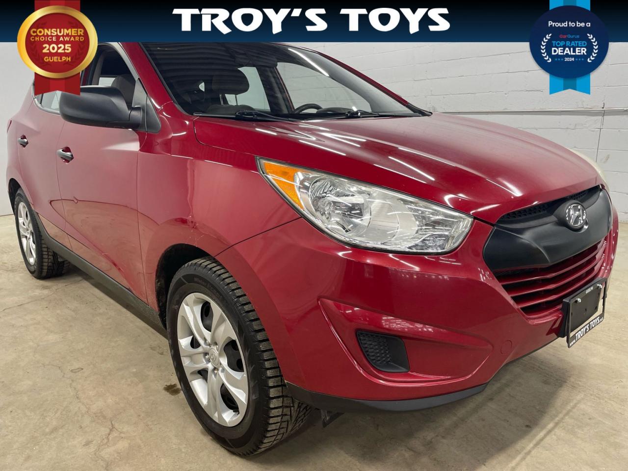 <p>Get ready to hit the road in style with this dependable 2012 Hyundai Tucson GL from Troys Toys! This sleek red SUV boasts a comfortable grey interior and a host of features that will make every drive a pleasure. With its 4-cylinder engine, automatic transmission, and front-wheel drive, this Tucson is ready to tackle your daily commute and weekend adventures with ease.</p><p>This Tucson is packed with features, including heated front seats, heated mirrors, power windows, keyless entry, and a tilt steering wheel. Enjoy the convenience of cruise control, a trip computer, and steering wheel audio controls. Stay safe with a suite of safety features such as anti-lock brakes, brake assist, stability control, and multiple airbags. This Tucson is ready to take you wherever you need to go.</p><p>Dont miss out on this fantastic opportunity to own a reliable and stylish SUV at Troys Toys. With 117,209km on the odometer, this Tucson is ready for its next adventure. Come see it for yourself today!</p><p><em>Powered by AutoIntelligence™ AI</em></p>