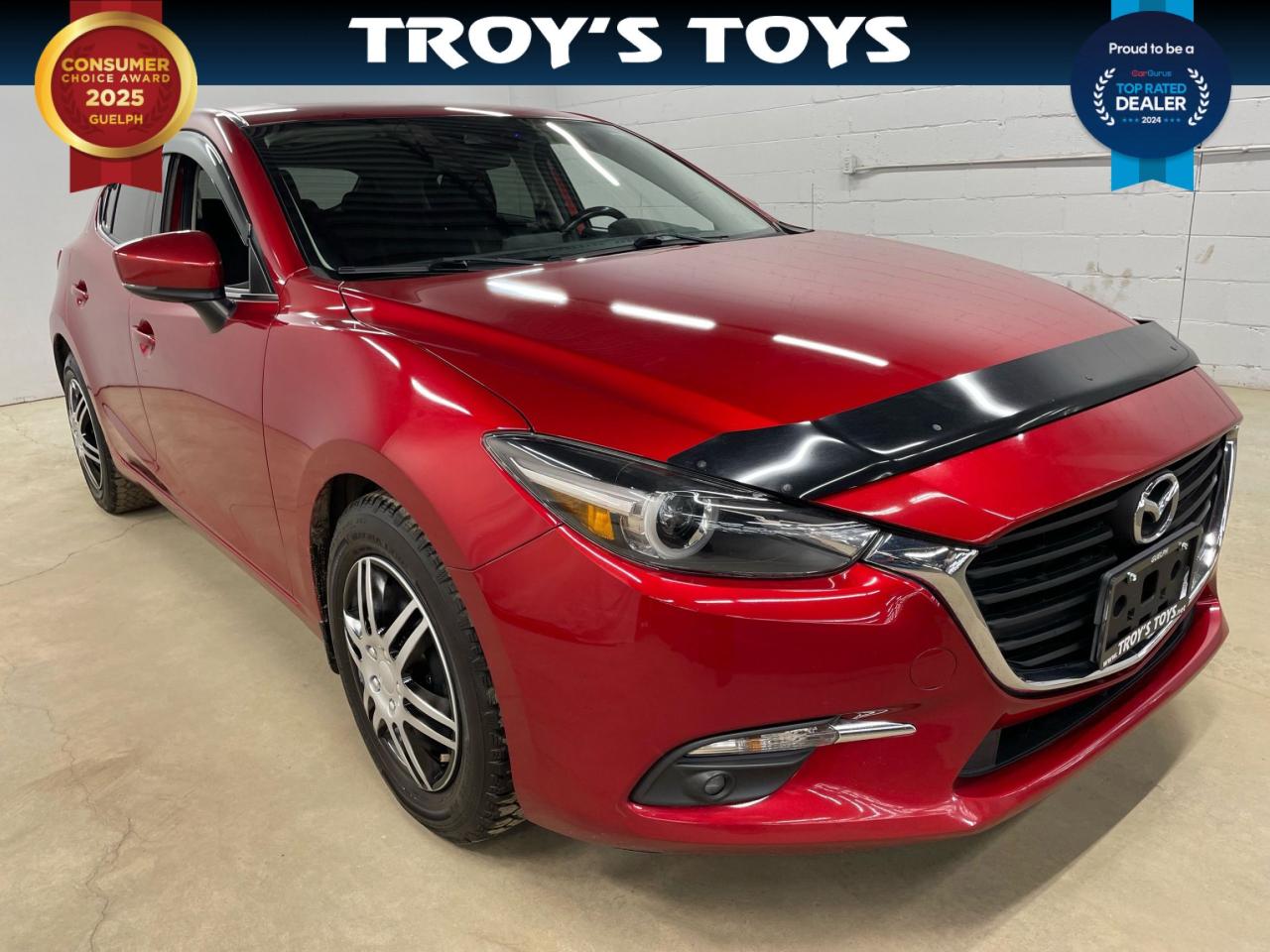 <p>Get ready to experience the thrill of driving a sporty and stylish sedan with the 2017 Mazda MAZDA3 GT, now available at Troys Toys. This sleek red beauty boasts a black interior and is sure to turn heads wherever you go. Equipped with a powerful engine, a smooth manual transmission, and front-wheel drive, this MAZDA3 GT delivers a dynamic and engaging driving experience. With only 111,374km on the odometer, this vehicle is in excellent condition and ready to take you on countless adventures.</p><p>Step inside and be greeted by a comfortable and well-appointed cabin. Enjoy the convenience of heated seats, a heated steering wheel, and keyless entry and start. Stay connected on the road with features like Bluetooth connectivity, a backup camera, and a touchscreen infotainment system. The MAZDA3 GT also comes equipped with a comprehensive suite of safety features including blind spot monitoring, cross-traffic alert, and lane departure warning.</p><p>Here are some standout features that make this 2017 MAZDA3 GT a real standout:</p><ol><li><strong>Manual Transmission:</strong> Embrace the pure driving experience with a precise and engaging manual transmission.</li><li><strong>Heated Steering Wheel:</strong> Enjoy warmth and comfort on those chilly mornings with the heated steering wheel.</li><li><strong>Heated Seats:</strong> Experience the ultimate comfort and warmth with the heated front seats.</li><li><strong>Backup Camera:</strong> Park with ease and confidence thanks to the rearview camera.</li></ol><p>Dont miss your chance to own this fantastic 2017 MAZDA3 GT, available now at Troys Toys.</p><p><em>Powered by AutoIntelligence™ AI</em></p>