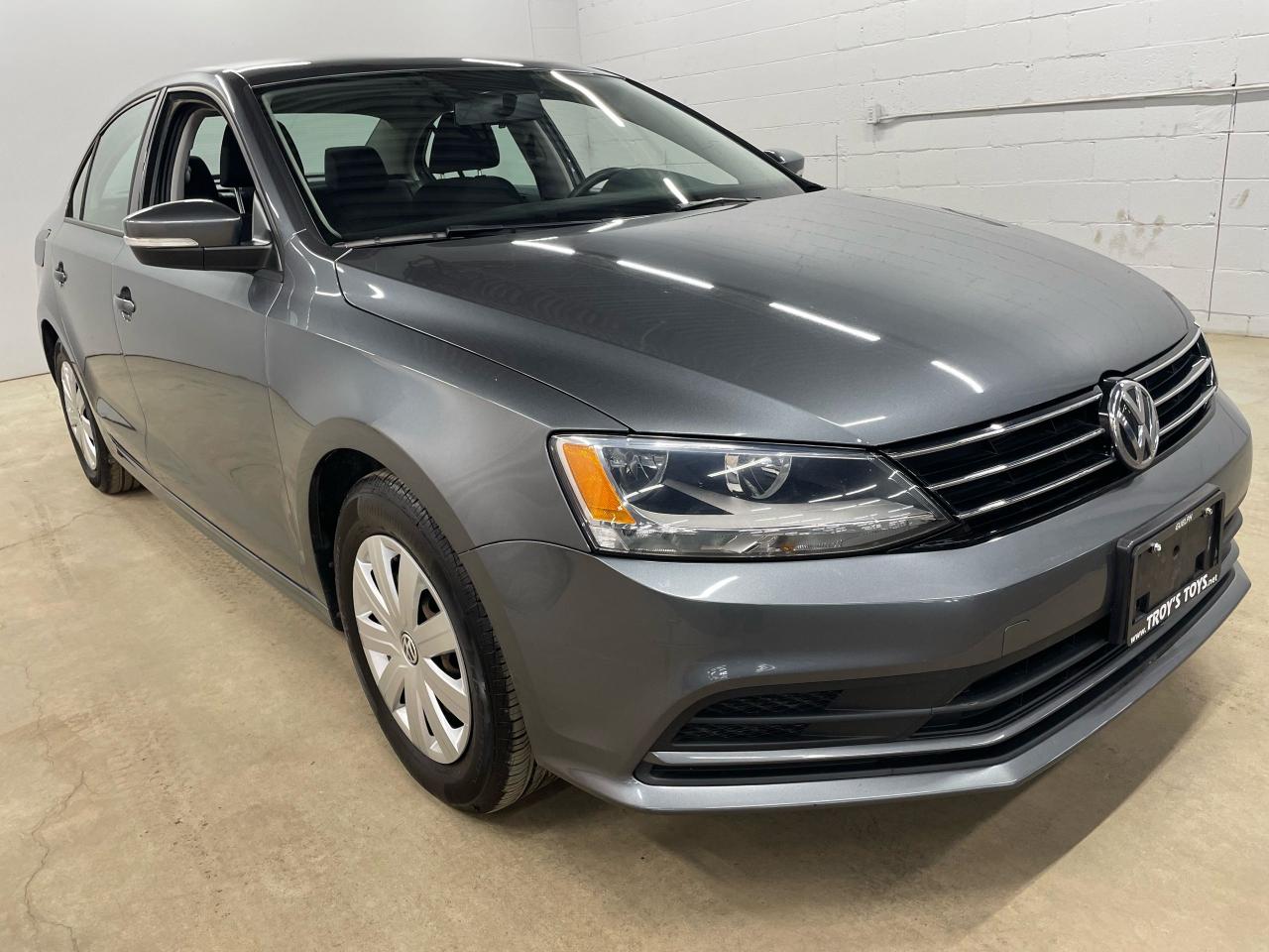 <p>Looking for a reliable and affordable sedan? Look no further than this 2016 Volkswagen Jetta Trendline, available now at Troys Toys. This sleek gray sedan boasts a spacious and comfortable interior with gray cloth seats, perfect for everyday commutes and weekend adventures. Under the hood, the Jetta packs a punch with a powerful engine, paired with a smooth automatic transmission, ensuring a smooth and efficient ride.</p><p>This well-maintained Jetta has been driven 117,065km and is packed with features that enhance both safety and convenience. Enjoy peace of mind with its comprehensive safety suite, including anti-lock brakes, stability control, and multiple airbags. Stay connected and entertained with the built-in CD player, auxiliary audio input, and steering wheel audio controls. The Jetta also includes a rear-view camera for added peace of mind when parking or reversing.</p><p>Here are just a few of the Jettas most enticing features:</p><ul><li><strong>Back-Up Camera:</strong> Navigate tight spaces with ease and confidence, thanks to the clear and convenient rear-view camera.</li><li><strong>Stability Control:</strong> Maintain control in challenging driving conditions with the stability control system, keeping you and your passengers safe.</li><li><strong>Steering Wheel Audio Controls:</strong> Enjoy the convenience of changing tracks and volume without taking your hands off the wheel.</li><li><strong>Tilt Steering Wheel:</strong> Find your perfect driving position with the adjustable tilt steering wheel, for a comfortable and personalized ride.</li><li><strong>Power Windows:</strong> Enjoy the convenience of power windows, for easy access and ventilation in any weather.</li></ul><p><em>Powered by AutoIntelligence™ AI</em></p>