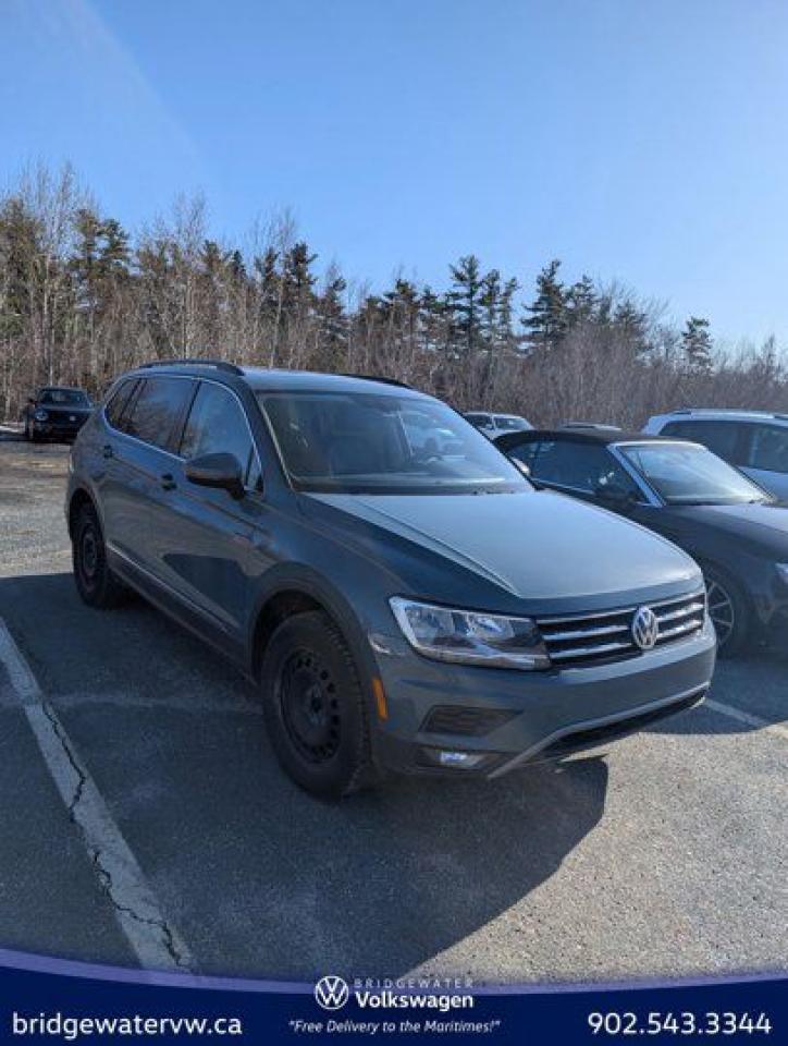 Recent Arrival! Stone Blue Metallic 2021 Volkswagen Tiguan Comfortline 4Motion | Apple CarPlay | Android Auto AWD 8-Speed Automatic with Tiptronic 2.0L TSI Bridgewater Volkswagen, Located in Bridgewater Nova Scotia.AWD, 3.33 Axle Ratio, 4-Wheel Disc Brakes, 6 Speakers, ABS brakes, Air Conditioning, Alloy wheels, AM/FM radio: SiriusXM, Auto-dimming Rear-View mirror, Automatic temperature control, Brake assist, Bumpers: body-colour, Compass, Delay-off headlights, Driver door bin, Driver vanity mirror, Dual front impact airbags, Dual front side impact airbags, Electronic Stability Control, Exterior Parking Camera Rear, Four wheel independent suspension, Front anti-roll bar, Front Bucket Seats, Front dual zone A/C, Front fog lights, Front reading lights, Fully automatic headlights, Heated door mirrors, Heated Front Comfort Seats, Heated front seats, Illuminated entry, Leather Shift Knob, Leatherette Seating Surfaces, Low tire pressure warning, Navigation System, Occupant sensing airbag, Outside temperature display, Overhead airbag, Overhead console, Panic alarm, Panoramic Power Sunroof, Passenger door bin, Passenger vanity mirror, Power door mirrors, Power driver seat, Power Liftgate, Power steering, Power windows, Radio data system, Radio: 8.0 Touchscreen Infotainment System, Rain sensing wipers, Rear anti-roll bar, Rear reading lights, Rear window defroster, Rear window wiper, Remote keyless entry, Roof rack: rails only, Security system, Speed control, Speed-sensing steering, Split folding rear seat, Spoiler, Standard Suspension, Steering wheel mounted audio controls, Tachometer, Telescoping steering wheel, Tilt steering wheel, Traction control, Trip computer, Turn signal indicator mirrors, Variably intermittent wipers, Wheels: 7J x 17 Tulsa Alloy.Volkswagen Certified Details:* Any remaining new-vehicle limited warranty. Certified Pre-Owned vehicles are eligible for extended warranty coverage, giving you greater peace of mind* Finance rates from 4.99%* A 6-month subscription to Volkswagen 24-hour roadside assistance* Prepaid Maintenance is now available for Certified Pre-Owned Volkswagens. Lock in your maintenance fees by choosing between a 2- or 3-year plan. Vehicles up to 7 years of age are eligible for the purchase of our Prepaid Maintenance plans regardless of mileage. A 3-month SiriusXM all-access trial subscription / Recent college, CEGEP or university Graduates can get a $500 rebate / CARFAX Vehicle History Report. A 3-month SiriusXM all-access trial subscription* A completed 112-point inspection plus mechanical and appearance reconditioning assessment performed by a Volkswagen factory-trained technicianReviews:* Owners and experts alike almost universally count the Tiguans ride quality, highway manners, interior, and overall easy-to-drive character among its most valuable assets. The central touchscreen infotainment system and all-digital instrument cluster are commonly listed as feature favourites, as they add a high-tech flair to the driving environment. Source: autoTRADER.ca