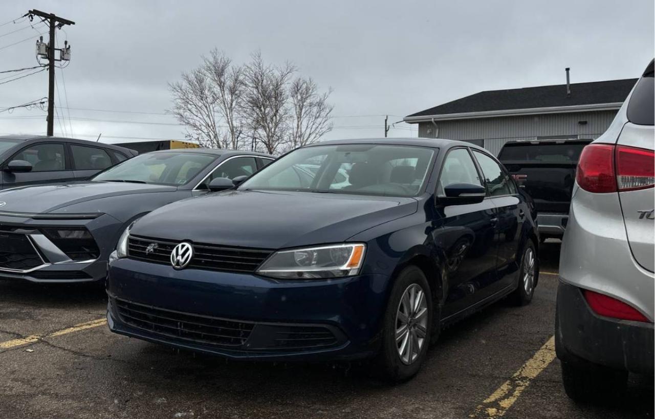 <p>Looking for a reliable and stylish sedan with a touch of European flair? Look no further than this 2014 Volkswagen Jetta COMFORTLINE, available at 613 Rides! This sleek blue beauty boasts a spacious black interior and a powerful 2L I4 engine paired with a smooth manual transmission for an engaging driving experience. With a well-maintained 146,572km on the odometer, this Jetta is ready to hit the road and take you wherever you need to go.</p><p>Enjoy the comfort and convenience of a wide array of features, including heated seats and mirrors to keep you warm in the Canadian winter, a sunroof for those sunny days, and a powerful sound system with SiriusXM Radio and Bluetooth connectivity. The Jetta also offers advanced safety features such as anti-lock brakes, traction control, and multiple airbags for peace of mind on the road.</p><p>This 2014 Volkswagen Jetta COMFORTLINE is a fantastic option for drivers seeking a blend of style, performance, and affordability. With a warranty available, you can drive confidently knowing youre backed by 613 Rides commitment to quality and customer satisfaction. Contact us today to schedule a test drive and experience this great car for yourself!</p><p><strong>Here are 5 key features with sizzle:</strong></p><ul><li><strong>Sunroof:</strong> Let the sunshine in and enjoy the open-air feeling with the sunroof.</li><li><strong>Heated Seats & Mirrors:</strong> Stay warm and cozy even on the coldest Canadian days.</li><li><strong>SiriusXM Radio & Bluetooth Connectivity:</strong> Enjoy your favorite music and stay connected on the go.</li><li><strong>Manual Transmission:</strong> Engage with the driving experience and enjoy the control of a manual gearbox.</li><li><strong>Warranty Available:</strong> Drive with confidence knowing you have the added peace of mind of a warranty.</li></ul><p><em>Powered by AutoIntelligence™ AI</em></p>