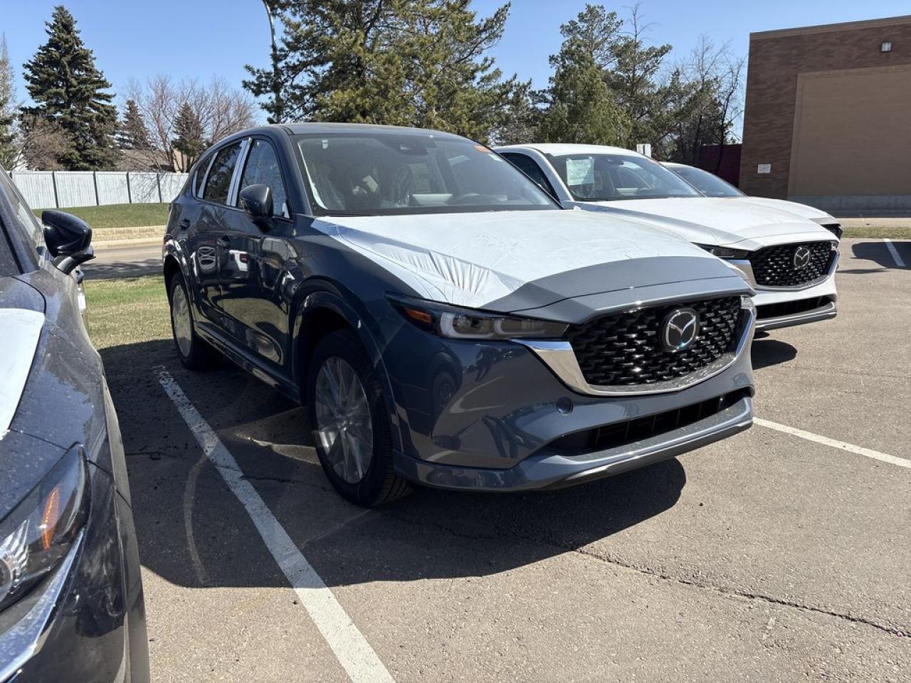 <p>NEW 2025 CX-5 GT AWD. Bluetooth, Skyactiv-G 2.5 L (Inline-4) Cylinder Deactivation. Backup Cam, Available NAV, Leather Heated/Ventilated Seats, Power Front Seats, Memory Driver Seat, Rear Heated Seats, Wireless Apple CarPlay/Android Auto, Wireless Phone Charger, Bose Premium Sound System, Advanced Keyless Remote Entry, Tilt/Sliding Moonroof, Power Trunk, Adaptive Cruise Control, Heated Steering Wheel, Wiper Blade De-Icer, Auto Dual-Zone Climate Control, Rear Air Vents, Auto Rain-Sensing Wipers, Electronic Parking Brake, Heated Mirrors, 19 Silver Metallic Alloy Wheels</p>  <p>Includes:</p> <p>i-ACTIVSENSE + Safety Features (Smart City Brake Support-Front, Cruise Traffic Support, Rear Cross Traffic Alert, Mazda Radar Cruise Control With Stop & Go, Distance Recognition Support System, Lane-Keep Assist System, Lane Departure Warning System, Advanced Blind Spot Monitoring)</p>  <p>A joy to drive, our 2025 Mazda CX-5 GT AWD radiates refined style in Polymetal Grey Metallic! Motivated by a 2.5 Liter 4 Cylinder that delivers 187hp tethered to a paddle-shifted 6 Speed Automatic transmission. You can put that strength to good use with the added traction of torque vectoring, and this All Wheel Drive SUV returns nearly approximately 7.8L/100km on the highway. Our CX-5 also has an expressive design with bold details like 19-inch alloy wheels, a rear roof spoiler, and bright-tipped dual exhaust outlets.</p>  <p>Our GT cabin is no ordinary interior. Its tailor-made for better travel with heated leather power front seats, a leather-wrapped steering wheel, automatic climate control, pushbutton ignition, and keyless access. Mazda makes connecting easy by providing a 10.25-inch central display, a multifunction Commander controller, Apple CarPlay/Android Auto, Bluetooth, voice control, and six-speaker audio. The versatile rear cargo space adds adventure-friendly functionality.</p>  <p>Safety is a high priority for Mazda, which helps protect you and your loved ones with automatic emergency braking, adaptive cruise control, a rearview camera, lane-keeping assistance, blind-spot monitoring, and other intelligent technologies. With all that, our CX-5 GT is here to transcend the ordinary! Save this page, Come in for a Qualified Test Drive. We Know You Will Enjoy Your Test Drive Towards Ownership!</p>  <p>Call 587-409-5859 for more info or to schedule an appointment! Listed Pricing is valid for 72 hours. Financing is available, please see dealer for term availability and interest rates. AMVIC Licensed Business.</p>