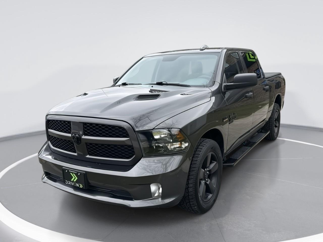 <p>Step into the world of powerful performance with this sleek and stylish Gray 2021 Ram 1500 Classic Express 4x4 Crew Cab. Equipped with a robust 5.7L 8-cylinder engine and smooth automatic transmission, it promises a driving experience that's both commanding and effortless no matter the terrain.</p>  <p>The exterior boasts a sophisticated yet rugged appearance, highlighted by its durable body and contemporary gray finish, complemented by striking alloy wheels. Inside, the black interior creates a refined atmosphere, made for comfort and convenience with ample passenger space and ergonomic design. Key features such as remote start and keyless entry elevate the everyday driving experience to pure convenience.</p>  <p>This Ram 1500 doesnt stop at style and comfort; it comes loaded with cutting-edge technology and safety features. Enjoy seamless connectivity with a Bluetooth connection while the backup camera and brake assist enhance your driving confidence. Stay cool and comfortable with air conditioning and easily control your driving environment with power windows and cruise control. Heated mirrors ensure clear visibility during frosty Canadian mornings.</p>  <p>Perfect for adventurous individuals who need a reliable truck for both work and leisure, or families looking for space and safety in style  this truck has a lot to offer. Feel free to connect with us to get more details or book a test drive.<br /> Contact us today and experience why the Ram 1500 Classic is the truck that Canadians trust.</p> <p><strong>Why Buy from DRIVEN?</strong></p><p>At <strong>DRIVEN</strong>, we're <strong>Ontarios Premier Dealership</strong>, committed to making your car-buying experience <strong>easy, transparent, and stress-free</strong>. Unlike other dealers who sneak in extra fees for certification, our pricing is <strong>all-inclusive</strong>no hidden fees, just <strong>sales tax and licensing</strong>.</p><p>Every vehicle comes with a <strong>complimentary Carfax history report</strong> and has passed a <strong>rigorous 150-point inspection</strong> and <strong>reconditioning</strong> process at our state-of-the-art service facility. We dont just meet minimum safety standardswe <strong>exceed them</strong>, including a <strong>fresh oil change</strong> and ensuring all <strong>service requirements are up to date</strong>. Plus, for <strong>added peace of mind</strong>, every vehicle is backed by our <strong>30-Day / 2,500 KM Assurance Program</strong>.</p><p>Looking to trade in? <strong>We get you top dollar</strong> by exposing your vehicle to online auctions across Canada.</p><p>Not buying from us? <strong>No problemwell still buy your car!</strong></p><p>But dont just take our word for itour <strong>Glowing 5-star Google Reviews</strong> speak for themselves. See why so many customers trust us to help them find the perfect car!</p><p><strong>>> Advertised Price Reflects a $2,000 Finance Credit. Cash Price May Vary. <<</strong></p>
