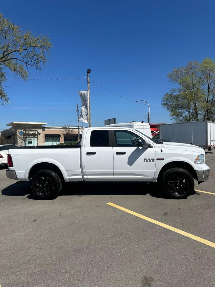 2016 RAM 1500 4WD Quad Cab 140.5" Outdoorsman Photo