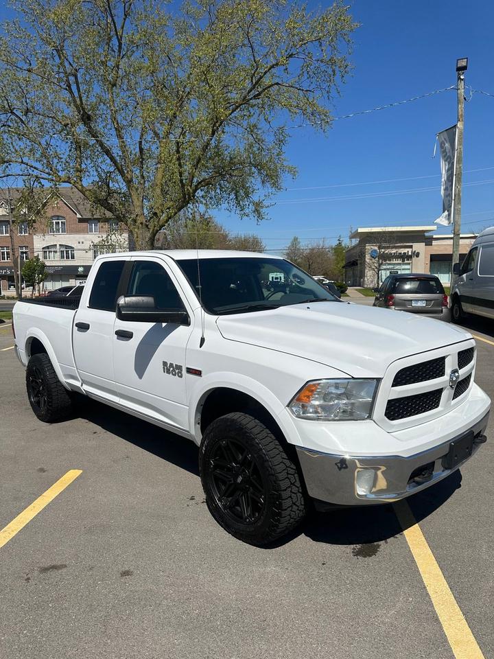2016 RAM 1500 4WD Quad Cab 140.5" Outdoorsman Photo