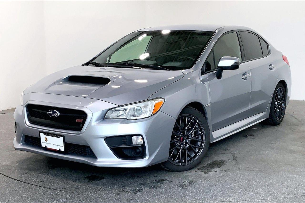 This Vehicle is Highly Equipped with Multi-Level Heated Front Seats, Rear View Camera, Auxiliary Audio Input with USB, Heated Mirrors, Cruise Control, Leather Steering Wheel, and much more! 2016 Subaru WRX STI 4Dr 6sp comes in Ice Silver Metallic with a Black Interior! This is a Local BC Vehicle! We Accept All Trade-Ins and Buy-Ins!! For more details or to schedule a test drive with one of our highly trained sales executives please call or send a website enquiry now before it is gone. 604-530-8911. Porsche Center Langley has won the prestigious Porsche Premier Dealer Award eight years in a row. We are centrally located just a short distance from Highway 1 in beautiful Langley, British Columbia. Our hope is to have you driving your dream vehicle soon. Please note that additional fees, including a $599 documentation fee & a $690 dealer prep fee, apply to all pre-owned vehicles. Dealer #40136