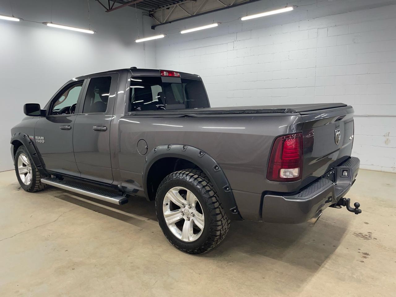 2014 RAM 1500 4WD QUAD CAB 140.5" SPORT Photo4