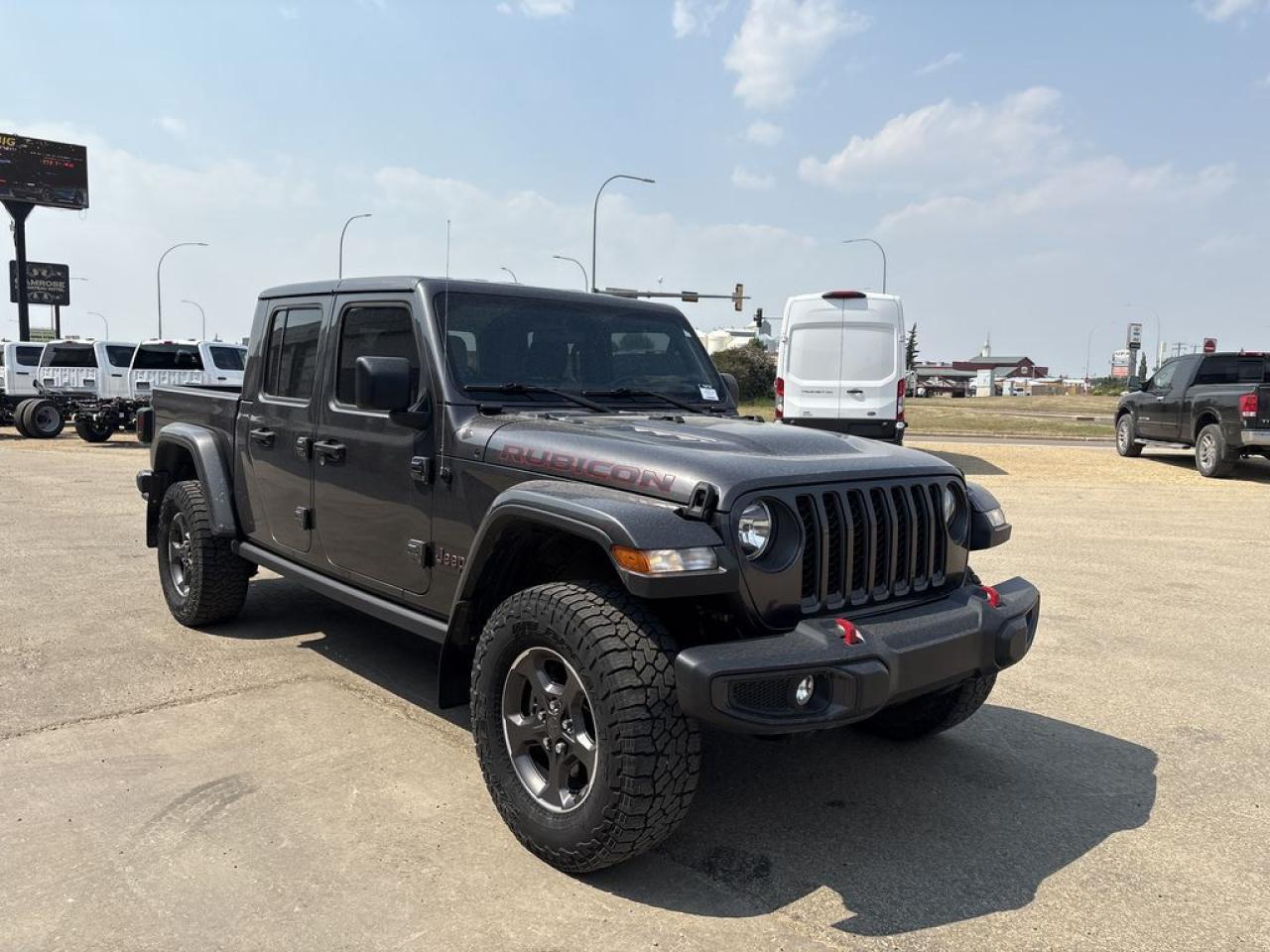 THE PRICE YOU SEE, PLUS GST. GUARANTEED!    APPLE CARPLAY/ANDROID AUTO COMPATABLE! 3.6 LITER PENTASTAR V6, 8 SPEED AUTO, TRAILER TOW PKG, LEATHER WRAPPED STEERING WHEEL, LEATHER FACED SEATS, 3 PIECE MODULAR HARD TOP, ROCK RAILS, REMOTE STARTER.      The 2021 Jeep Gladiator Rubicon 4x4 with the 3.6-liter V6 engine is a highly capable midsize pickup truck designed for off-road adventures and rugged terrain. Powered by the Pentastar 3.6-liter V6 engine, it delivers 285 horsepower and 260 lb-ft of torque, providing ample power for both on- and off-road driving. The Rubicon trim is specifically engineered for serious off-road performance, featuring exclusive features such as electronic locking differentials, a disconnecting front sway bar for improved wheel articulation, and heavy-duty Dana 44 axles. Its 4x4 drivetrain offers excellent traction and stability, complemented by a low-range transfer case for challenging terrains. The Gladiator Rubicon also boasts a robust off-road suspension system, skid plates for underbody protection, and aggressive off-road tires. Inside, it offers a modern cabin with a Uconnect infotainment system, available leather upholstery, and standard safety features. Overall, the 2021 Jeep Gladiator Rubicon 4x4 with the 3.6-liter engine combines rugged off-road capability with practical utility, making it a versatile choice for outdoor enthusiasts and truck lovers alike.Do you want to know more about this vehicle, CALL, CLICK OR COME ON IN!*AMVIC Licensed Dealer; CarFax and Full Mechanical Inspection Included.
