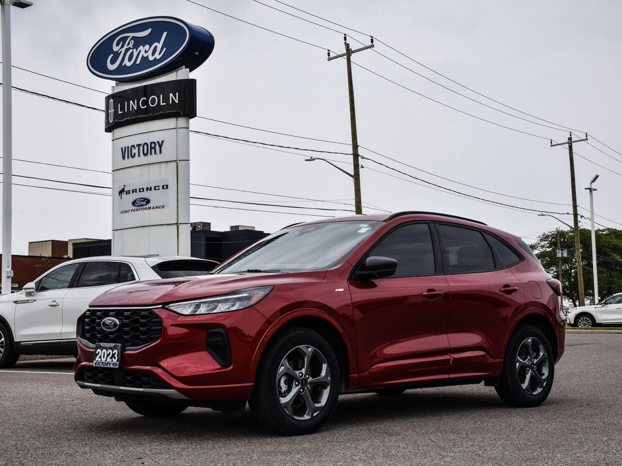 <p><strong>NOW AVAILABLE AT VICTORY FORD LINCOLN</strong></p>

<h3><strong>2023 FORD ESCAPE ST-LINE AWD</strong></h3>

<p><em>With<strong>Technology Package #1</strong>&<strong>Sport Appearance</strong></em><br />
<em>Sporty Performance Meets Cutting-Edge Tech</em></p>

<p>This head-turning Escape ST-Line delivers<strong>athletic handling</strong>and<strong>premium technology</strong>, wrapped in Fords bold ST styling for an exhilarating drive.</p>

<hr />
<h3><strong>ST-LINE PERFORMANCE</strong></h3>

<p>?<strong>2.0L EcoBoost® Turbocharged Engine</strong>(250HP/280 lb-ft)<br />
?<strong>8-Speed Automatic Transmission</strong><br />
?<strong>Sport-Tuned Suspension</strong><br />
?<strong>Dual Exhaust with Bright Tips</strong><br />
?<strong>AWD with Selectable Drive Modes</strong></p>

<hr />
<h3><strong>TECHNOLOGY PACKAGE #1</strong></h3>

<p><strong>12.3 Digital Instrument Cluster</strong><br />
<strong>Adaptive Cruise Control with Stop-and-Go</strong><br />
<strong>Evasion Steer Assist</strong></p>

<hr />
<h3><strong>ST-LINE EXCLUSIVES</strong></h3>

<p>?<strong>19 Dark Alloy Wheels</strong><br />
?<strong>Black Mesh Grille with ST-Line Badging</strong><br />
?<strong>Sport-Fabric Seats with Contrast Stitching</strong><br />
?<strong>Paddle Shifters</strong><br />
?<strong>LED Fog Lamps</strong></p>

<hr />
<p><span style=font-size:11pt><span style=font-family:Calibri,sans-serif><strong>Special Offer:</strong></span></span></p>

<p><span style=font-size:11pt><span style=font-family:Calibri,sans-serif><strong>Financing Special:</strong>Listed price available on approved credit for financed purchases. Pricing may vary with alternative payment methods.</span></span></p>

<p><span style=font-size:11pt><span style=font-family:Calibri,sans-serif><strong>Peace of Mind Included:</strong><br />
<span style=font-family:Segoe UI Symbol,sans-serif>?</span><strong>3-Month Comprehensive Warranty</strong>(for vehicles under 10 years old & under 160,000 km)<br />
<span style=font-family:Segoe UI Symbol,sans-serif>?</span><strong>No-Haggle, Live Market Pricing</strong> Transparent & Competitive<br />
<span style=font-family:Segoe UI Symbol,sans-serif>?</span><strong>All-Inclusive Pricing:</strong>Fees, Reconditioning, and Full Detailing Included (<em>Taxes & Licensing Extra</em>)</span></span></p>

<hr />
<p><span style=font-size:11pt><span style=font-family:Calibri,sans-serif><strong>Additional Details:</strong></span></span></p>

<ul>
 <li><span style=font-size:11pt><span style=font-family:Calibri,sans-serif><strong>Keys:</strong>Standard with one key. Additional keys (if provided by the previous owner) included at no cost. Optional key purchases available upon request.</span></span></li>
</ul>

<p><span style=font-size:11pt><span style=font-family:Calibri,sans-serif><strong>Visit Victory Ford Lincoln Today</strong><br />
<em>Schedule your appointment to experience this exceptional vehicle.</em></span></span></p>