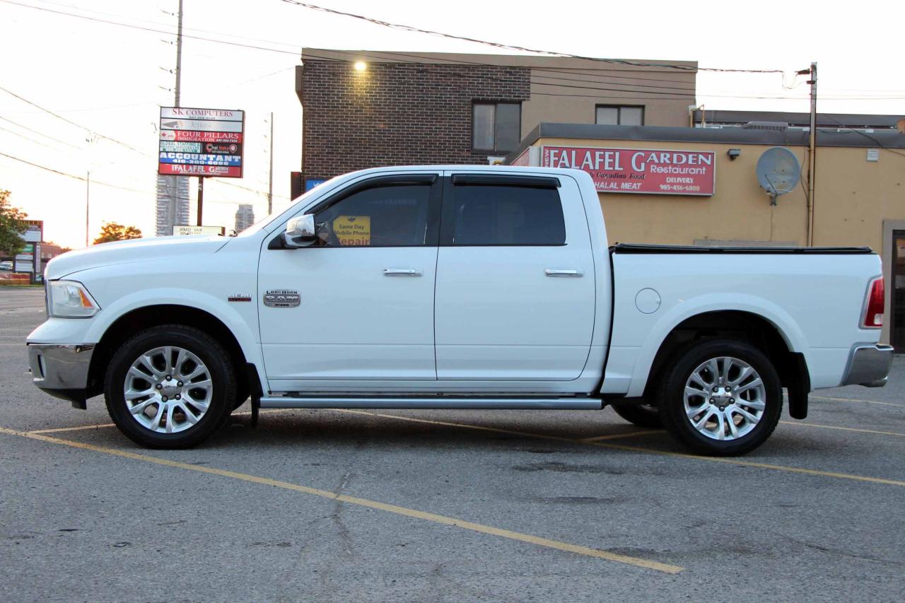2013 RAM 1500 4WD Crew Cab 140.5" Laramie Longhorn Photo3