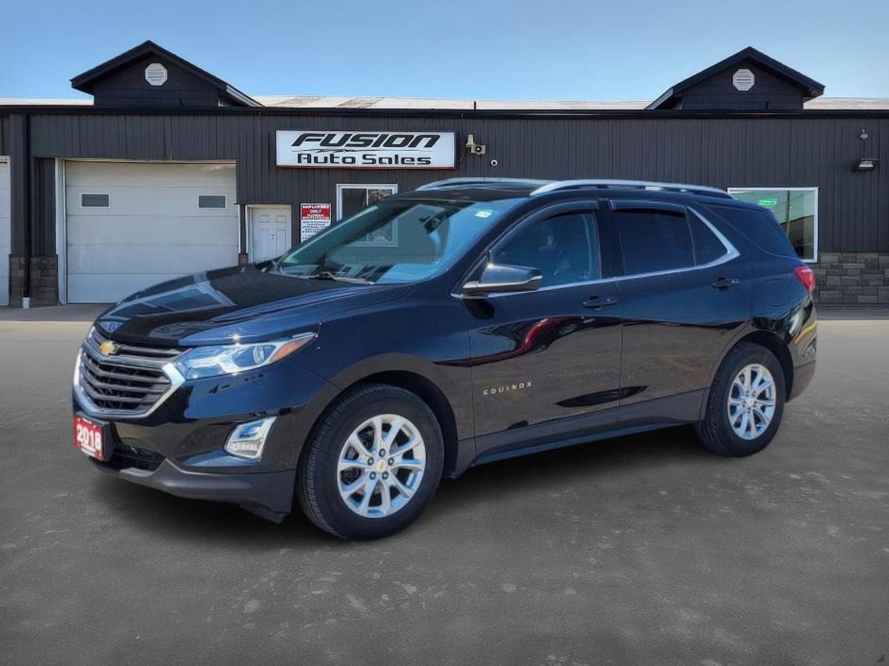 <p>1.5L 4Cyl, Auto, Power Panoramic Sunroof with Power Sunshade, Remote Start, Heated Seats, Back up Camera, Power Rear Liftgate, Power Drivers Seat, Alloy Wheels, Touch Screen, Audio Steering Wheel Controls, Information System and more. Lic & HST Extra.</p><p>Cruise the Canadian roads in style and comfort with this sleek, used 2018 Chevrolet Equinox LT, now available at Fusion Auto Sales! This stylish black SUV boasts a sophisticated gray interior, offering a perfect blend of practicality and elegance for your daily commute or weekend adventures. Powered by a fuel-efficient 1.5L V4 Turbo engine and paired with a smooth automatic transmission, this Equinox delivers a responsive and enjoyable driving experience. With 102,164km on the odometer, this well-maintained vehicle is ready to provide years of reliable service.</p><p>Imagine yourself enjoying the open road with these amazing features!</p><ul><li><strong>Panoramic Sunroof</strong>: Bask in the Canadian sun and enjoy breathtaking views with the expansive panoramic sunroof.</li><li><strong>Remote Start</strong>: Beat the winter chill or summer heat with the convenience of remote start, ensuring your Equinox is always ready when you are.</li><li><strong>Heated Seats</strong>: Experience ultimate comfort with heated seats, perfect for those chilly Canadian mornings.</li><li><strong>Turbocharged Engine:</strong> Feel the exhilarating power and efficiency of the 1.5L V4 Turbo engine.</li><li><strong>Spacious Interior</strong>: Enjoy ample room for passengers and cargo, making this Equinox the perfect companion for family trips or hauling gear.</li></ul><p><strong><em>Powered by AutoIntelligence&trade;</em></strong> Vehicle information has been generated using artificial intelligence and is provided for informational purposes only. While efforts are made to ensure accuracy, please confirm all details directly with the dealer.</p><p>The Fusion Philosophy<br><br>At Fusion Auto Sales, we put more effort into buying our vehicles than we do trying to sell them. By constantly monitoring what other car lots are doing, we strive to be the lowest priced dealer in our market. We won&rsquo;t purchase a vehicle to &ldquo;fill a hole&rdquo;. We know that the vehicles on our lot are great value for the money and smart shoppers realize that also. Adhering to this philosophy makes it easy for our customers. If they find a vehicle on our lot that fulfills their needs and wants, they know that they&rsquo;re getting great value. <br><br>If we don&rsquo;t have what you&rsquo;re looking for, we can find it! Over 150 customers have saved thousands of dollars buy joining our&rdquo; locate club&rdquo;. People that know what they want and what they want to pay (within reason of course), get the vehicle of their dreams and enjoy huge savings. Contact us for details.<br><br><br><br>Fusion Auto Sales is in Tilbury, Ont. located between Windsor and London right off the 401. We are among 7 dealerships within a &frac12; kilometer distance which is great for out of town shoppers. We began satisfying customers in 2009 and have been doing so ever since. In 2012 Fusion was recognized as 1 of the 50 fastest growing companies in Canada. And then, in 2018, we were named one of the top 5 independent automobile dealerships in the country. <br><br>We specialize in late model vehicles at below than average pricing, everything is fully certified and every unit is Car Proof verified and is fully disclosed with every unit. We offer every type of financing from perfect credit at great rates to credit challenges with competitive rates. We also specialize in locating vehicles for customers, we cant have everything on the lot so if you do not see it and are having a hard time finding what you are looking for, let us know and we can find it for you. Fusion Auto Sales spans its customer base from Windsor all the way to Timmins, On and every where in between. Our philosophy is You are going to like the way we deal and everyone does, straight honest answers with no monkey business and no back and forth between sales and managers.</p>