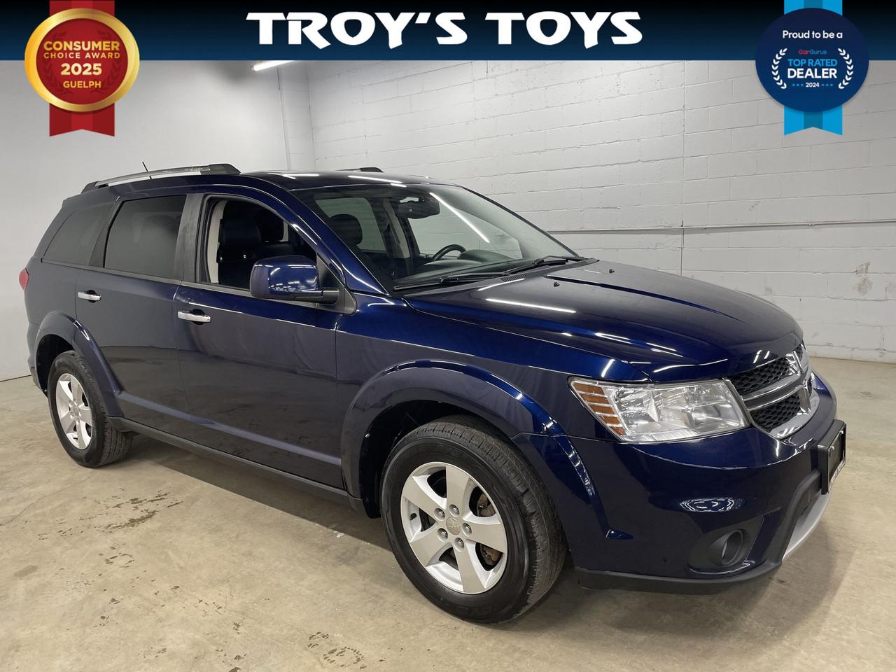 <p>Looking for a versatile and family-friendly SUV? Check out this used 2017 Dodge Journey GT, available now at Troys Toys! This striking blue beauty offers ample space and features to make every drive a pleasure. With its robust all-wheel-drive system, youll be ready to tackle those challenging Canadian roads, no matter the weather. Plus, with seating for seven passengers, theres room for the whole family, and then some. This Journey has 176,423km on the odometer.</p><p>This Dodge Journey GT is designed for convenience and comfort. The sleek black interior provides a stylish and comfortable environment. The automatic transmission makes for a smooth and effortless driving experience. Whether youre commuting to work or embarking on a weekend adventure, this SUV is prepared for the journey.</p><p>Here are five features that make this 2017 Dodge Journey GT stand out:</p><ul><li><strong>All-Wheel Drive:</strong> Conquer any weather condition with confidence.</li><li><strong>7-Passenger Seating:</strong> Bring the whole family, plus friends!</li><li><strong>Rear Entertainment System:</strong> Keeps the back seat entertained on long drives.</li><li><strong>Automatic Transmission:</strong> For smooth and effortless driving.</li><li><strong>Striking Blue Exterior:</strong> Turn heads wherever you go.</li></ul><p><strong><em>Powered by AutoIntelligence&trade;</em></strong> Vehicle information has been generated using artificial intelligence and is provided for informational purposes only. While efforts are made to ensure accuracy, please confirm all details directly with the dealer.</p>
