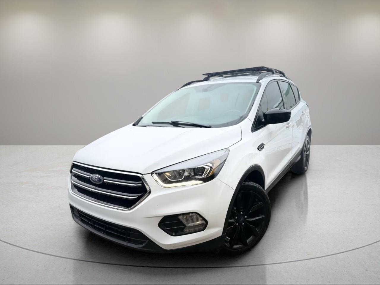 <p>Experience the 2018 Ford Escape SE in a pristine white finish with front-wheel drive that offers smooth handling around city streets and highways.</p><p>The exterior of this SUV is complemented by alloy wheels that add a touch of style and functionality. Inside, a welcoming gray interior awaits, designed for comfort with heated front seats and power-adjustable options. The Escape SEs interior is not just about comfort, but it also offers practical features such as power windows and keyless entry for added convenience.</p><p>Stay connected and entertained on the go with modern technology including Bluetooth connectivity and smart device integration. The satellite radio provides entertainment for all your journeys. In terms of safety, this vehicle includes a backup camera to assist in tight spots, brake assist for enhanced stopping power, and heated mirrors to cope with Canadas chilly conditions.</p><p>Perfect for professionals and families alike, the 2018 Ford Escape SE caters to those seeking a reliable, feature-packed SUV. Contact us today for more information and to schedule a test drive. Let this Ford Escape be your next dependable companion on the road.</p>