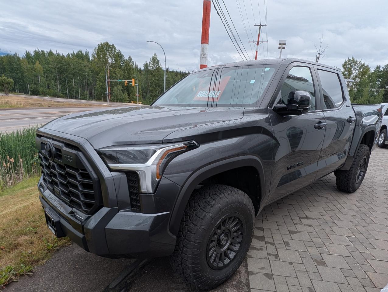 <p>Looking for a powerful and luxurious pickup truck? Feast your eyes on the brand-new 2025 Toyota Tundra Limited, now available at Smithers Toyota! This stunning truck, finished in a sleek Magnetic Grey Metallic exterior, is ready to turn heads on the streets and conquer any terrain. Inside, youll find a refined black interior with SofTex seat trim, offering both comfort and durability. With its robust 4-wheel drive system and a suite of advanced features, the Tundra Limited is built to handle anything you throw its way.</p><p> </p><p>This Tundra Limited is more than just a workhorse; its a haven of modern technology and convenience. From its advanced safety features to its premium interior, every detail has been carefully considered to enhance your driving experience. Whether youre navigating city streets or venturing off the beaten path, the 2025 Toyota Tundra Limited from Smithers Toyota is the perfect blend of capability, comfort, and style.</p><p> </p><p>Here are five standout features that make this Tundra Limited truly exceptional:</p><p><br /><br /></p><ul><ul><li><strong>TRD Off Road Package:</strong> Take your adventures to the next level with this package, designed for superior off-road performance.</li></ul></ul><p> </p><ul><ul><li><strong>Heated & Ventilated Front Bucket Seats:</strong> Experience ultimate comfort with 8-way power-adjustable seats, perfect for any weather.</li></ul></ul><p> </p><ul><ul><li><strong>Express Open/Close Sunroof:</strong> Enjoy the open air and natural light with the touch of a button.</li></ul></ul><p> </p><ul><ul><li><strong>Advanced Safety Suite:</strong> Drive with confidence thanks to features like Pre-Collision System, Blind Spot Monitor, and Rear Cross Traffic Alert.</li></ul></ul><p> </p><ul><ul><li><strong>Powerful i-FORCE Twin Turbo V6 Engine:</strong> Experience impressive power and efficiency with this cutting-edge engine.</li></ul></ul><p><br /><br /></p><p><strong><em>Powered by AutoIntelligence™</em></strong><br />Vehicle information has been generated using artificial intelligence and is provided for informational purposes only. While efforts are made to ensure accuracy, please confirm all details directly with the dealer.</p><p> </p>