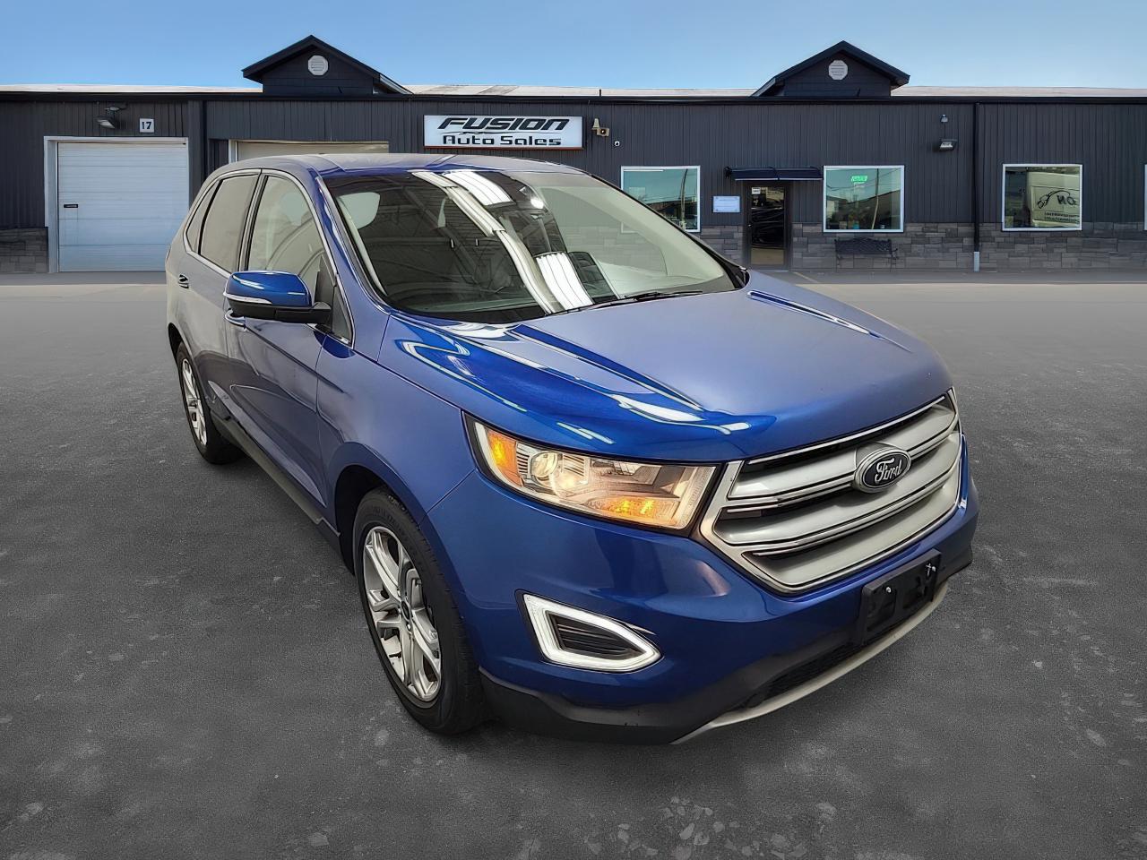 <p>UNIT IN TRANSIT.</p><p>Looking for a stylish and capable SUV thats ready for anything? Then check out this beautiful 2018 Ford Edge Titanium, available now at Fusion Auto Sales! This eye-catching crossover boasts a sleek blue exterior complemented by a luxurious black leather interior. With its efficient 2.0L Turbocharged V4 engine and smooth automatic transmission, youll enjoy a responsive and comfortable driving experience, whether youre navigating city streets or embarking on a weekend adventure. This well-maintained Edge has 151,217km on the odometer and is ready to provide you with years of reliable service.</p><p>This 2018 Ford Edge Titanium is packed with features designed to elevate your driving experience. Here are some highlights that are sure to impress:</p><ul><li><strong>Turbocharged Power:</strong> Experience thrilling acceleration and confident passing thanks to the responsive turbocharged engine.</li><li><strong>Luxurious Leather:</strong> Sink into the comfort of premium black leather seats, adding a touch of elegance to every journey.</li><li><strong>Effortless Automation:</strong> Enjoy the convenience of a smooth-shifting automatic transmission, making your daily commute a breeze.</li><li><strong>Stylish SUV Design:</strong> Turn heads with the Edges modern and sophisticated exterior, showcasing a blend of sporty and practical elements.</li><li><strong>Front-Wheel Drive Confidence:</strong> Experience secure handling and stability in various driving conditions with the front-wheel-drive system.</li></ul><p><strong><em>Powered by AutoIntelligence™</em></strong> Vehicle information has been generated using artificial intelligence and is provided for informational purposes only. While efforts are made to ensure accuracy, please confirm all details directly with the dealer.</p><p> </p><p>The Fusion Philosophy<br /><br />At Fusion Auto Sales, we put more effort into buying our vehicles than we do trying to sell them. By constantly monitoring what other car lots are doing, we strive to be the lowest priced dealer in our market. We won’t purchase a vehicle to “fill a hole”. We know that the vehicles on our lot are great value for the money and smart shoppers realize that also. Adhering to this philosophy makes it easy for our customers. If they find a vehicle on our lot that fulfills their needs and wants, they know that they’re getting great value. <br /><br />If we don’t have what you’re looking for, we can find it! Over 150 customers have saved thousands of dollars buy joining our” locate club”. People that know what they want and what they want to pay (within reason of course), get the vehicle of their dreams and enjoy huge savings. Contact us for details.<br /><br /><br /><br />Fusion Auto Sales is in Tilbury, Ont. located between Windsor and London right off the 401. We are among 7 dealerships within a &frac12; kilometer distance which is great for out of town shoppers. We began satisfying customers in 2009 and have been doing so ever since. In 2012 Fusion was recognized as 1 of the 50 fastest growing companies in Canada. And then, in 2018, we were named one of the top 5 independent automobile dealerships in the country. <br /><br />We specialize in late model vehicles at below than average pricing, everything is fully certified and every unit is Car Proof verified and is fully disclosed with every unit. We offer every type of financing from perfect credit at great rates to credit challenges with competitive rates. We also specialize in locating vehicles for customers, we cant have everything on the lot so if you do not see it and are having a hard time finding what you are looking for, let us know and we can find it for you. Fusion Auto Sales spans its customer base from Windsor all the way to Timmins, On and every where in between. Our philosophy is You are going to like the way we deal and everyone does, straight honest answers with no monkey business and no back and forth between sales and managers.</p>