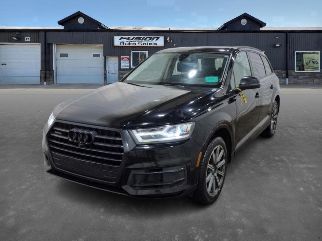 <p>2.0L 4Cyl Turbocharged, 252 HP, 8 Speed Automatic Transmission with Tiptronic, 7 Passenger Third Row Seating with Power Folding Third Row, Full Leather Interior with Heated/Cooled Seats, Heated 2nd Row Seating, Navigation, Power Panoramic Sunroof with Power Sunshade, Power Seats, Rear/Front/Side Cameras, Ally Wheels, Bluetooth, Power Rear Liftgate and more. Lic & HST Extra.</p><p>Are you looking for a luxurious and capable SUV that seamlessly blends performance and practicality? Feast your eyes on this stunning 2018 Audi Q7 2.0 TFSI quattro Progressiv, now available at Fusion Auto Sales. This sophisticated SUV, cloaked in a sleek black exterior, exudes an air of timeless elegance that is sure to turn heads. With its robust 2.0L Turbocharged engine and quattro all-wheel-drive system, the Q7 delivers a thrilling driving experience, perfect for navigating both city streets and challenging terrains with confidence.</p><p>Step inside and youll be greeted by a refined black leather interior, offering a sanctuary of comfort and style. This Audi Q7, with 156,567km on the odometer, has been meticulously maintained and is ready to provide you with years of reliable service. Its spacious cabin offers ample room for passengers and cargo, making it an ideal choice for families and adventure seekers alike. The automatic transmission ensures a smooth and effortless ride, allowing you to fully enjoy the journey.</p><p>Here are five standout features that make this 2018 Audi Q7 a must-see:</p><ul><li><strong>Quattro All-Wheel Drive:</strong> Experience unparalleled grip and control in all weather conditions.</li><li><strong>Turbocharged Engine:</strong> Enjoy exhilarating acceleration and responsive performance.</li><li><strong>Luxurious Leather Interior:</strong> Indulge in premium comfort and sophistication.</li><li><strong>Spacious Cabin:</strong> Benefit from ample room for passengers and cargo.</li><li><strong>Elegant Design:</strong> Turn heads with its timeless and sophisticated aesthetic.</li></ul><p><strong><em>Powered by AutoIntelligence™</em></strong> Vehicle information has been generated using artificial intelligence and is provided for informational purposes only. While efforts are made to ensure accuracy, please confirm all details directly with the dealer.</p><p>The Fusion Philosophy<br /><br />At Fusion Auto Sales, we put more effort into buying our vehicles than we do trying to sell them. By constantly monitoring what other car lots are doing, we strive to be the lowest priced dealer in our market. We won’t purchase a vehicle to “fill a hole”. We know that the vehicles on our lot are great value for the money and smart shoppers realize that also. Adhering to this philosophy makes it easy for our customers. If they find a vehicle on our lot that fulfills their needs and wants, they know that they’re getting great value. <br /><br />If we don’t have what you’re looking for, we can find it! Over 150 customers have saved thousands of dollars buy joining our” locate club”. People that know what they want and what they want to pay (within reason of course), get the vehicle of their dreams and enjoy huge savings. Contact us for details.<br /><br /><br /><br />Fusion Auto Sales is in Tilbury, Ont. located between Windsor and London right off the 401. We are among 7 dealerships within a &frac12; kilometer distance which is great for out of town shoppers. We began satisfying customers in 2009 and have been doing so ever since. In 2012 Fusion was recognized as 1 of the 50 fastest growing companies in Canada. And then, in 2018, we were named one of the top 5 independent automobile dealerships in the country. <br /><br />We specialize in late model vehicles at below than average pricing, everything is fully certified and every unit is Car Proof verified and is fully disclosed with every unit. We offer every type of financing from perfect credit at great rates to credit challenges with competitive rates. We also specialize in locating vehicles for customers, we cant have everything on the lot so if you do not see it and are having a hard time finding what you are looking for, let us know and we can find it for you. Fusion Auto Sales spans its customer base from Windsor all the way to Timmins, On and every where in between. Our philosophy is You are going to like the way we deal and everyone does, straight honest answers with no monkey business and no back and forth between sales and managers.</p>