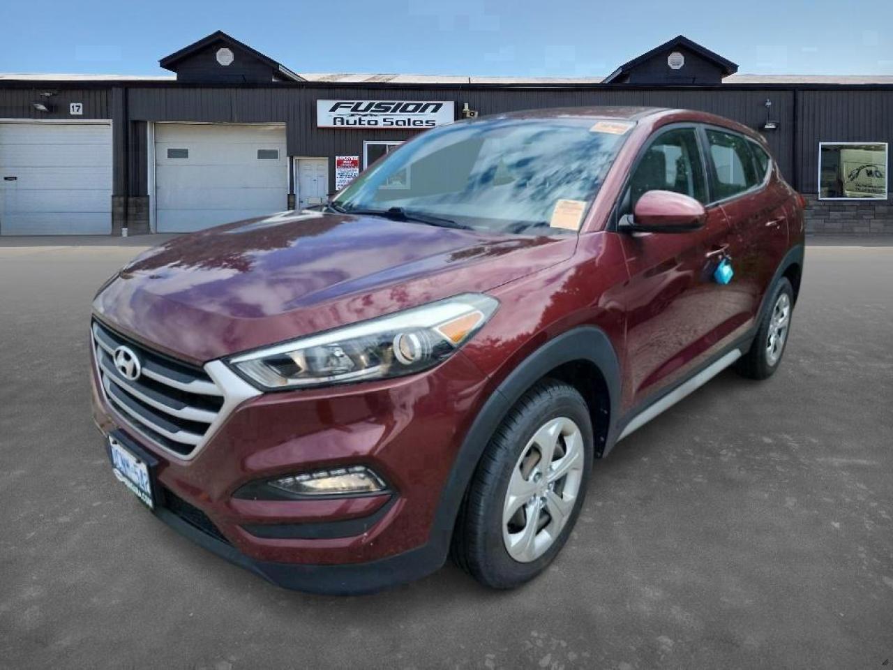 <p>Looking for a reliable and stylish SUV thats perfect for navigating Canadian roads? Check out this pre-owned 2017 Hyundai Tucson, available now at Fusion Auto Sales! This sleek crossover boasts a head-turning maroon exterior, paired with a comfortable light grey interior, creating a sophisticated and inviting atmosphere. With only 83,851 km on the odometer, this Tucson is ready to provide years of dependable service. Its practical design and efficient 2L V4 engine make it an ideal choice for both city commutes and weekend adventures.</p><p>This Tucson is packed with features designed to enhance your driving experience. Here are a few highlights youll love:</p><ul><li><strong>Smooth Automatic Transmission:</strong> Enjoy effortless gear changes and a relaxed driving experience, perfect for stop-and-go traffic or long highway drives.</li><li><strong>Front-Wheel Drive:</strong> Experience confident handling and improved fuel efficiency in various driving conditions.</li><li><strong>Spacious SUV Design:</strong> Offers ample cargo space and comfortable seating for passengers.</li><li><strong>Fuel-Efficient Engine:</strong> The 2L V4 engine provides a great balance of power and fuel economy.</li><li><strong>Modern Convenience:</strong> Features to enhance your driving experience.</li></ul><p><strong><em>Powered by AutoIntelligence™</em></strong> Vehicle information has been generated using artificial intelligence and is provided for informational purposes only. While efforts are made to ensure accuracy, please confirm all details directly with the dealer.</p><p>The Fusion Philosophy<br /><br />At Fusion Auto Sales, we put more effort into buying our vehicles than we do trying to sell them. By constantly monitoring what other car lots are doing, we strive to be the lowest priced dealer in our market. We won’t purchase a vehicle to “fill a hole”. We know that the vehicles on our lot are great value for the money and smart shoppers realize that also. Adhering to this philosophy makes it easy for our customers. If they find a vehicle on our lot that fulfills their needs and wants, they know that they’re getting great value. <br /><br />If we don’t have what you’re looking for, we can find it! Over 150 customers have saved thousands of dollars buy joining our” locate club”. People that know what they want and what they want to pay (within reason of course), get the vehicle of their dreams and enjoy huge savings. Contact us for details.<br /><br /><br /><br />Fusion Auto Sales is in Tilbury, Ont. located between Windsor and London right off the 401. We are among 7 dealerships within a &frac12; kilometer distance which is great for out of town shoppers. We began satisfying customers in 2009 and have been doing so ever since. In 2012 Fusion was recognized as 1 of the 50 fastest growing companies in Canada. And then, in 2018, we were named one of the top 5 independent automobile dealerships in the country. <br /><br />We specialize in late model vehicles at below than average pricing, everything is fully certified and every unit is Car Proof verified and is fully disclosed with every unit. We offer every type of financing from perfect credit at great rates to credit challenges with competitive rates. We also specialize in locating vehicles for customers, we cant have everything on the lot so if you do not see it and are having a hard time finding what you are looking for, let us know and we can find it for you. Fusion Auto Sales spans its customer base from Windsor all the way to Timmins, On and every where in between. Our philosophy is You are going to like the way we deal and everyone does, straight honest answers with no monkey business and no back and forth between sales and managers.</p>