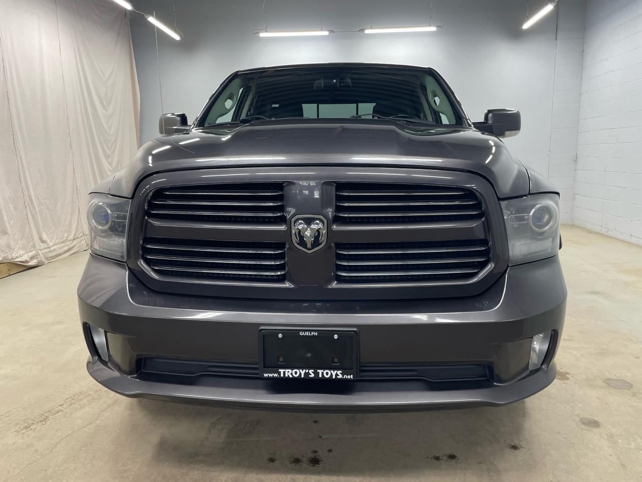 2014 RAM 1500 4WD QUAD CAB 140.5" SPORT Photo2