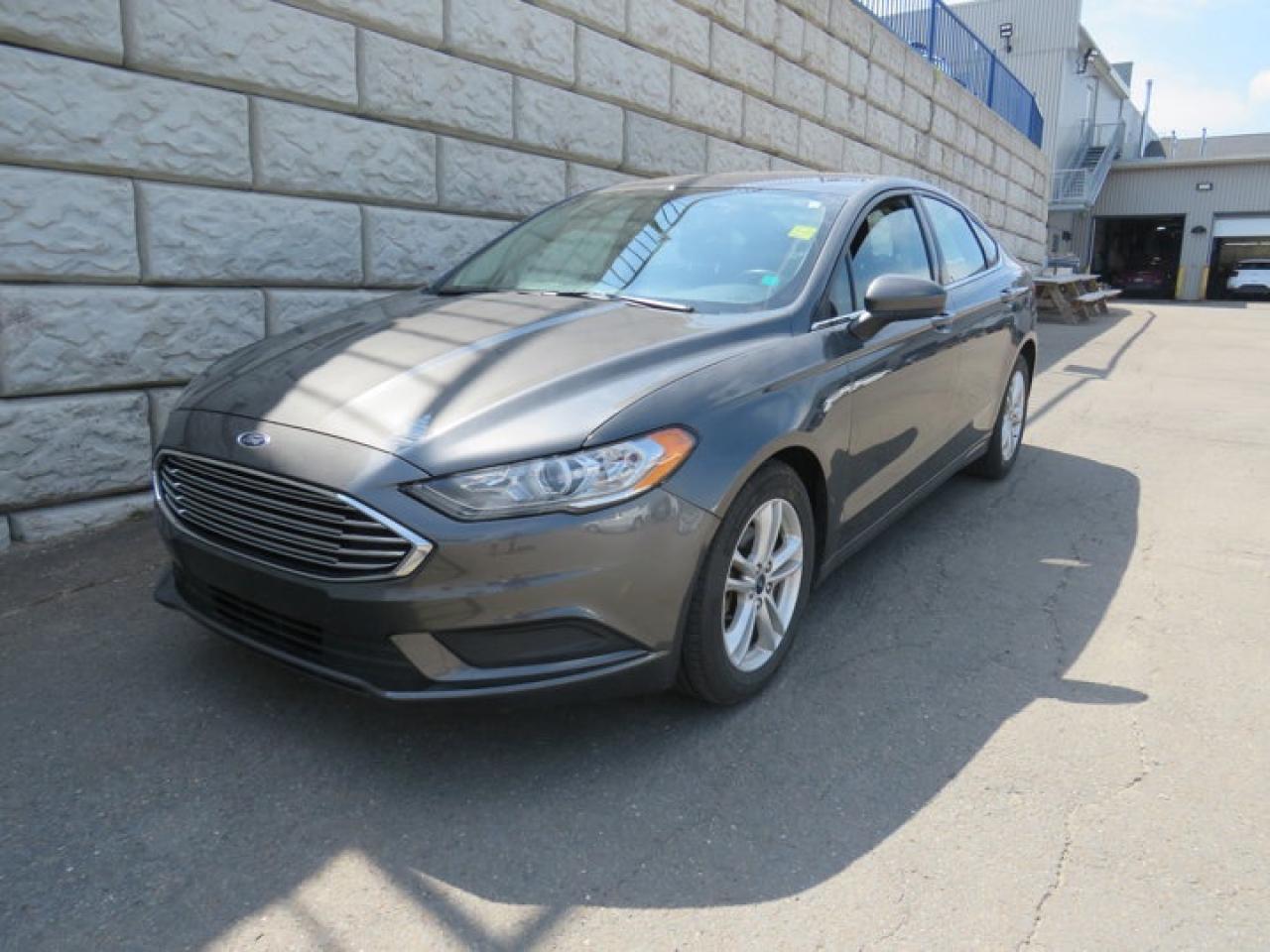 Recent Arrival!Magnetic 2018 Ford Fusion SE FWD 6-Speed Automatic 2.5L iVCT* Market Value Pricing *, 6-Speed Automatic.Steele GMC Buick Fredericton offers the full selection of GMC Trucks including the Canyon, Sierra 1500, Sierra 2500HD & Sierra 3500HD in addition to our other new GMC and new Buick sedans and SUVs. Our Finance Department at Steele GMC Buick are well-versed in dealing with every type of credit situation, including past bankruptcy, so all customers can have confidence when shopping with us!Steele Auto Group is the most diversified group of automobile dealerships in Atlantic Canada, with 47 dealerships selling 27 brands and an employee base of well over 2300.Reviews:* Owners tend to rate the Fusion highly in most aspects of ride quality, performance, fuel mileage, comfort, and versatility. The higher-output turbo engines are favourites amongst enthusiasts, and the up-level feature content adds extra appeal. Many owners also love the high-tech touches, including the MyFord Touch display and the Ford Sync central command system. Source: autoTRADER.ca