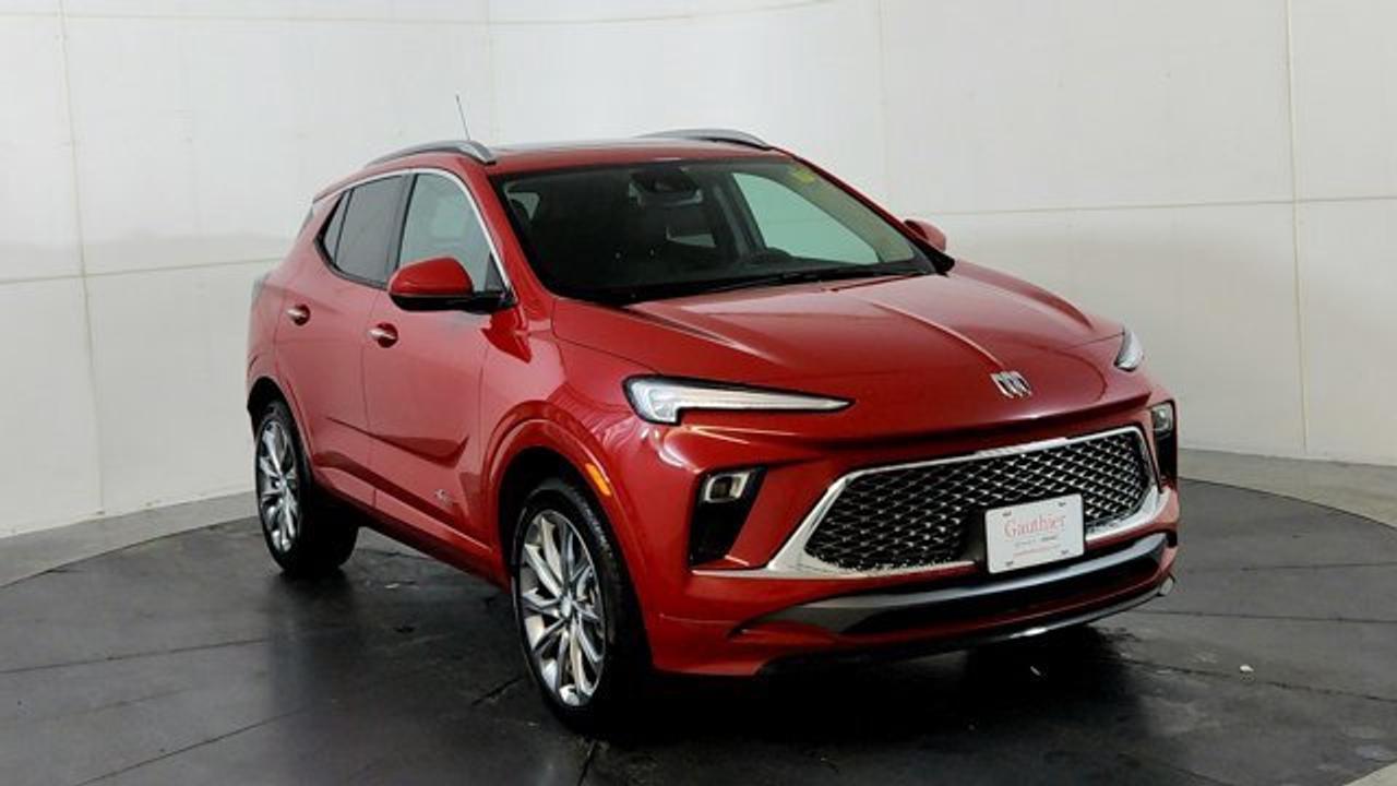 The Encore GX Sport Touring brings a sporty design with gloss-black exterior accents---such as an all-new black grille, black alloy wheels, LED taillamps, and body-color bumpers with unique styling touches. It is powered exclusively by the turbocharged 1.3 L ECOTEC three-cylinder engine (155 hp, 174 lb-ft) mated to a nine-speed automatic and all-wheel drive. Inside, the Sport Touring features leatherette seating with Santorini Blue stitching, an 11 ultrawide HD infotainment touchscreen supporting wireless Apple CarPlay and Android Auto, adaptive cruise control, rear park assist, HD surround vision and wireless charging. This model also includes a Black Roof package and a power moonroof.