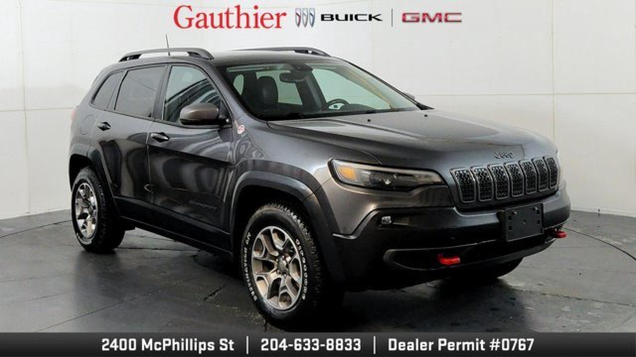 The 2021 Jeep Cherokee Trailhawk is an off-road-focused SUV designed for rugged performance, featuring Jeeps Active Drive Lock 4x4 system and a locking rear differential. It comes equipped with a 3.2L V6 engine, increased ground clearance, skid plates, and all-terrain tires for enhanced trail capability. Inside, it offers a comfortable cabin with an 8.4-inch touchscreen, Apple CarPlay and Android Auto, and a suite of optional features including a power liftgate, premium Alpine audio, a towing package 17-inch black aluminum wheels.