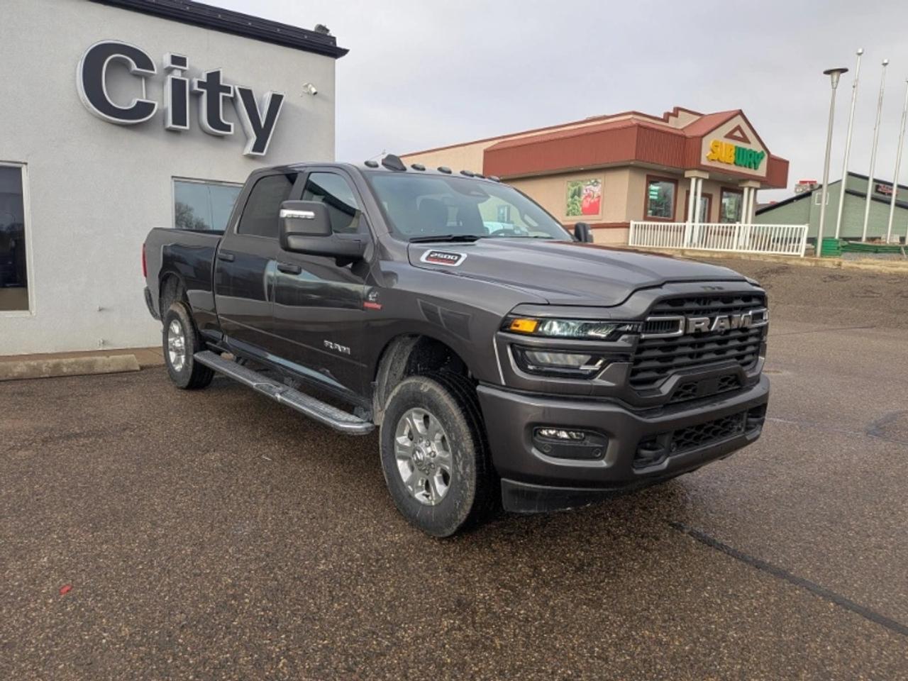 Introducing the formidable 2026 RAM 2500 Big Horn Crew Cab 4x4 a heavy-duty truck built to handle any challenge with confidence. This powerhouse is finished in a rugged and stylish Granite Crystal Metallic exterior a color that perfectly complements its robust design. The spacious Black interior is both durable and comfortable featuring premium cloth front bucket seats ready for the long haul.At the heart of this RAM 2500 is the legendary 6.7L Cummins I6 Turbo Diesel engine paired with a heavy-duty 6-speed TorqueFlite automatic transmission. This powertrain delivers immense torque and reliability making it the ideal choice for heavy towing and demanding work. The 4x4 system ensures you have the traction and control needed for any terrain or weather condition a crucial feature for the varied landscapes around Medicine Hat Alberta.This Big Horn is impressively equipped with the Big Horn Level 2 Plus Equipment Group which adds a host of premium features. The cabin is a modern command center with a Uconnect 5 with an 8.4-inch display GPS navigation and 4G LTE Wi-Fi hot spot keeping you connected wherever the job takes you. The 7-inch full-colour customizable in-cluster display provides vital vehicle information at a glance. Enjoy comfort in any weather with front heated seats and a heated steering wheel.Safety and convenience are paramount. The Full-Speed Forward Collision Warning Plus Adaptive Cruise Control with Stop and Lane Keep Assist provide advanced driver-assistance for a safer less-fatiguing drive. The ParkView Rear Back-Up Camera and Park-Sense Front and Rear Park Assist make maneuvering this large truck much easier. Practical features like Trailer Tow Pages and power folding mirrors further enhance its utility.The trucks rugged good looks are completed by 18-inch polished aluminum wheels and LED fog lamps. The Sport Appearance Package adds a touch of style with a body-colour bumper grille and door handles giving it a refined yet tough presence.As your trusted dealership serving Medicine Hat and surrounding communities like Taber Brooks and Maple Creek Saskatchewan we are dedicated to providing the highest quality trucks and exceptional service. Experience the power durability and luxury of this 2026 RAM 2500 Big Horn Crew Cab 4x4 for yourself.