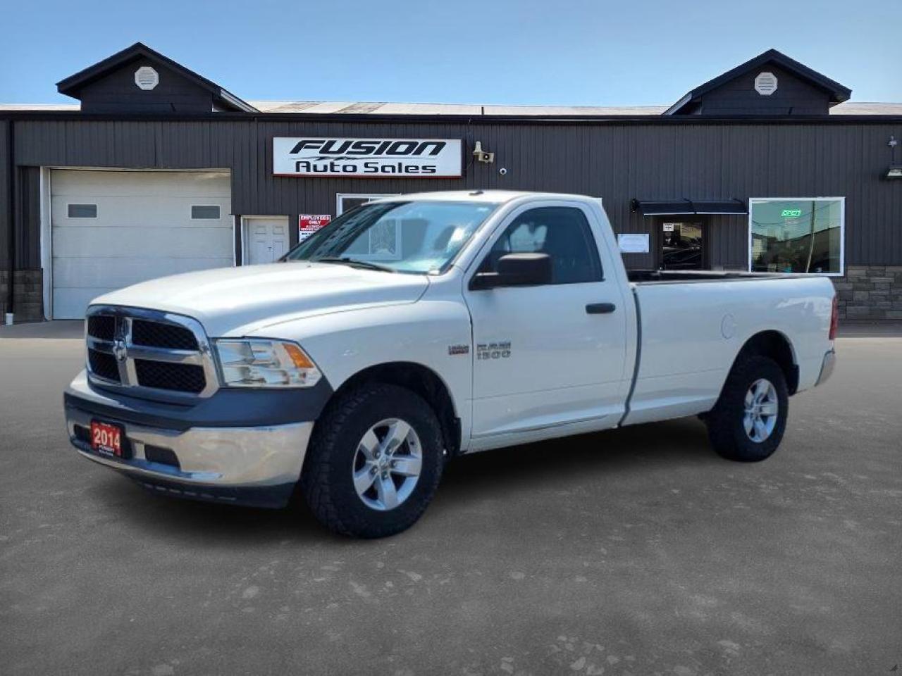 <p>Two prices right now, $15,995 certified without paint work, $18,995 with paint work done, once paint work is completed the lower price is off the table. 5.7L V8 Hemi, 4x4, Regular Cab Long Box, Loaded inside. Low Km for the year. Lic & HST Extra.</p><p>Looking for a reliable workhorse that can handle the Canadian landscape? Look no further than this rugged 2014 RAM 1500 ST, available now at Fusion Auto Sales. This white pickup truck is ready to tackle any job, from hauling equipment to weekend adventures. Its classic design and powerful presence make a statement wherever you go. The RAM 1500 ST is a testament to durability and practicality, ready to be your trusted partner on the road.</p><p>Under the hood, youll find a robust 5.7L V8 engine, paired with a smooth automatic transmission, offering impressive power and capability. With four-wheel drive, this truck is prepared to navigate challenging terrain and weather conditions, giving you the confidence to explore with ease. The interior boasts a comfortable gray cabin, making every drive a pleasant experience, whether its a quick trip to the hardware store or a long haul across the province.</p><p>Here are five sizzling features of this 2014 RAM 1500 ST:</p><ul><li><strong>V8 Powerhouse:</strong> Unleash the raw strength of a 5.7L V8, offering impressive towing capacity and a commanding presence on the road.</li><li><strong>Go-Anywhere Capability:</strong> Conquer snow, mud, and everything in between with the confidence of 4-wheel drive.</li><li><strong>Built to Last:</strong> A proven platform, the RAM 1500 ST is known for its durability and dependability.</li><li><strong>Classic Truck Styling:</strong> Turn heads with the timeless design and rugged appeal of this iconic pickup.</li><li><strong>Ready for Anything:</strong> From work to play, this truck is prepared to handle whatever you throw its way.</li></ul><p><strong><em>Powered by AutoIntelligence™</em></strong> Vehicle information has been generated using artificial intelligence and is provided for informational purposes only. While efforts are made to ensure accuracy, please confirm all details directly with the dealer.</p><p>The Fusion Philosophy<br /><br />At Fusion Auto Sales, we put more effort into buying our vehicles than we do trying to sell them. By constantly monitoring what other car lots are doing, we strive to be the lowest priced dealer in our market. We won’t purchase a vehicle to “fill a hole”. We know that the vehicles on our lot are great value for the money and smart shoppers realize that also. Adhering to this philosophy makes it easy for our customers. If they find a vehicle on our lot that fulfills their needs and wants, they know that they’re getting great value. <br /><br />If we don’t have what you’re looking for, we can find it! Over 150 customers have saved thousands of dollars buy joining our” locate club”. People that know what they want and what they want to pay (within reason of course), get the vehicle of their dreams and enjoy huge savings. Contact us for details.<br /><br /><br /><br />Fusion Auto Sales is in Tilbury, Ont. located between Windsor and London right off the 401. We are among 7 dealerships within a &frac12; kilometer distance which is great for out of town shoppers. We began satisfying customers in 2009 and have been doing so ever since. In 2012 Fusion was recognized as 1 of the 50 fastest growing companies in Canada. And then, in 2018, we were named one of the top 5 independent automobile dealerships in the country. <br /><br />We specialize in late model vehicles at below than average pricing, everything is fully certified and every unit is Car Proof verified and is fully disclosed with every unit. We offer every type of financing from perfect credit at great rates to credit challenges with competitive rates. We also specialize in locating vehicles for customers, we cant have everything on the lot so if you do not see it and are having a hard time finding what you are looking for, let us know and we can find it for you. Fusion Auto Sales spans its customer base from Windsor all the way to Timmins, On and every where in between. Our philosophy is You are going to like the way we deal and everyone does, straight honest answers with no monkey business and no back and forth between sales and managers.</p>