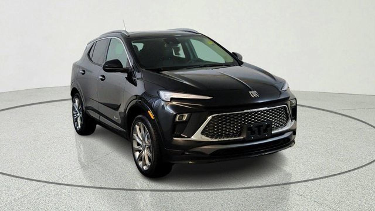 The 2026 Buick Encore GX Avenir elevates Buicks compact SUV to a new level of attainable luxury. Its exterior features distinctive Avenir styling---such as the Black Ice-finish grille, chrome beltline trim, clear-lens LED taillamps, and 19-inch Avenir Pearl Nickel alloy wheels---while the cabin includes perforated leather upholstery, heated power-adjustable front seats with driver memory, a heated steering wheel, a power-folding passenger seatback, auto-dimming rearview mirror, and a 120 V household-style outlet. Technology includes an 11-inch ultrawide touchscreen infotainment system paired with an 8-inch configurable driver display, wireless Apple CarPlay/Android Auto and Wi-Fi hotspot. This model also comes with a power moonroof, Rear Park Assist, Rainsense wipers and Bose premium 7-speaker audio system. Under the hood, it is powered by a turbocharged 1.3 L three-cylinder engine paired with a nine-speed automatic transmission and standard all-wheel drive.