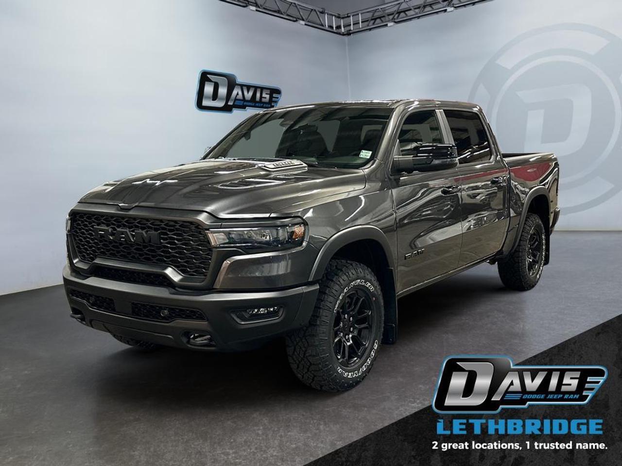 <b>Off-Road Suspension, Navigation, Apple CarPlay, Android Auto, Blind Spot Monitoring!<br /> <br /></b><br /> <br /> <br />The 2026 Ram 1500 Rebel in Granite Crystal Metallic is engineered for off-road adventure without compromising comfort or technology. Powered by a 3.0L I6 Hurricane Twin-Turbo engine and an 8-speed automatic transmission, paired with 4x4 drivetrain and 3.92 rear axle ratio, this crew cab Rebel delivers outstanding capability on any terrain. The raised ride height, off-road-tuned front and rear shocks, E-Locker rear axle, and skid plates make it trail-ready from day one.<br /><br />Inside, enjoy cloth/vinyl bucket seats with heating, dual wireless charging pads, Uconnect 5 NAV 14.4 touchscreen with Apple CarPlay and Android Auto, GPS navigation, premium Harman Kardon 19-speaker sound system, and dual-zone climate control. Additional comfort features include power 8-way driver and passenger seats with memory, heated second-row seats, full-length upgraded floor console, and active noise control.<br /><br />Safety is robust with Adaptive Cruise Control with Stop & Go, Blind Spot and Cross Path Detection, Active Lane Management, ParkView Rear Camera, Pedestrian Emergency Braking, and Full-Speed Forward Collision Warning. Exterior highlights feature black Rebel badging, sport performance hood, black grille and bumpers, dual black exhaust tips, 18 mid-gloss black wheels with all-terrain tires, tow hooks, and Class IV receiver hitchperfect for both work and play.<br /> <br />To apply right now for financing use this link: <a href=https://lethbridge.davisdodge.ca/free-credit-check/ target=_blank rel=nofollow noopener noreferrer>https://lethbridge.davisdodge.ca/free-credit-check/</a><br /><br /> <br /><br />As a premier Chrysler, Dodge, Jeep and RAM dealership, Davis Dodge proudly offers an extensive selection of new and used vehicles to meet every drivers needs. Customers across Lethbridge, Fort Macleod, Taber, Claresholm, Coaldale, and beyond trust us for daily vehicle specials, certified service and parts, and a seamless online inventory experience. <br /><br /> With competitive financing options and expert support, we make car buying easy and enjoyable. <br /><br /> Ready to hit the road? Schedule your test drive today at Davis Dodge, your trusted Chrysler, Dodge, Jeep and RAM dealer in Lethbridge, Alberta.<br /><br /> Vehicle pricing offer shown expires 2026-04-30. <br /> Come by and check out our fleet of 70+ used cars and trucks and 110+ new cars and trucks for sale in Lethbridge. o~o