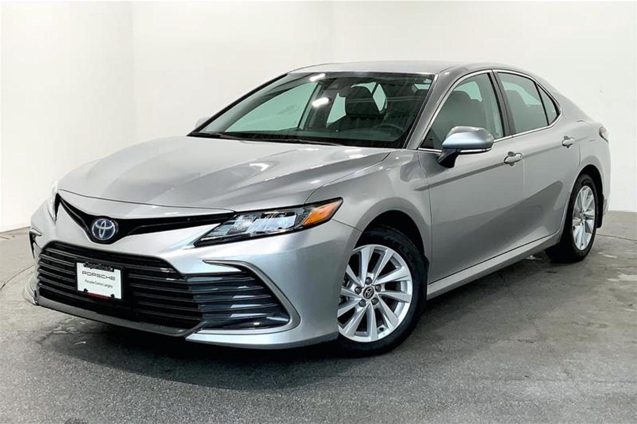 Highly Equipped with Android Auto/Apple CarPlay, Rear View Camera, Adaptive Cruise Control, Lane Departure Warning, Lane Keep Assist, Emergency Braking Assist, Dual Zone Front Climate Control, Keyless Ignition, 8-Way Power Driver Seat, Hands-Free Entry, and much more! 2022 Toyota Camry Hybrid LE comes in Celestial Silver Metallic with a Black Interior! This Local BC Vehicle has No Reported Accidents or Claims! We Accept All Trade-Ins and Buy-Ins!! For more details or to schedule a test drive with one of our highly trained sales executives, please send us a website inquiry before it&rsquo;s gone. Porsche Centre Langley has proudly earned the Porsche Premier Dealer Award eight years in a row. Conveniently located just off Highway 1 in Langley, British Columbia, we are committed to helping you find and drive your dream vehicle. Please note: A $599 documentation fee and a $690 dealer preparation fee apply to all pre-owned vehicles. Dealer #40136.