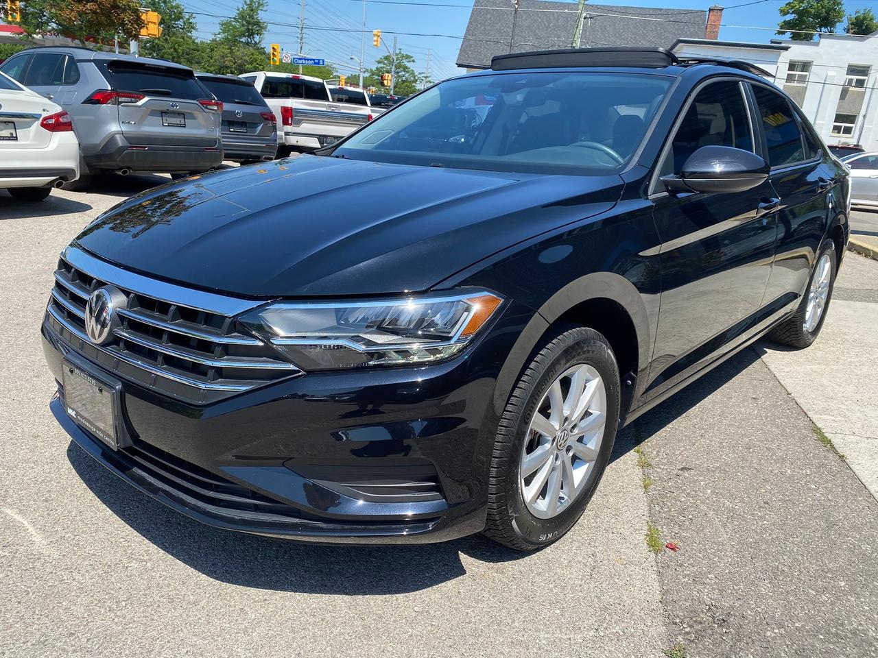 <p data-path-to-node=0><strong data-path-to-node=0 data-index-in-node=0>2021 Volkswagen Jetta Highline &ndash; Deep Black Pearl &ndash; 35,000 KM</strong></p><p data-path-to-node=1><strong data-path-to-node=1 data-index-in-node=0>Description:</strong> Experience the perfect combination of sophisticated German styling and exceptional fuel efficiency with this <strong data-path-to-node=1 data-index-in-node=122>2021 Volkswagen Jetta Highline</strong>. Finished in a sleek <strong data-path-to-node=1 data-index-in-node=174>Deep Black Pearl</strong> over a premium <strong data-path-to-node=1 data-index-in-node=206>Black Leather</strong> interior, this Jetta offers a refined, tech-forward driving experience that stands out in its class.</p><p data-path-to-node=2>With only <strong data-path-to-node=2 data-index-in-node=10>35,000 km</strong>, this vehicle is powered by a responsive 1.4L turbocharged engine paired with a smooth 8-speed automatic transmission. The Highline trim provides a significant jump in luxury and technology, featuring the impressive Volkswagen Digital Cockpit and a massive panoramic sunroof. It has been meticulously maintained and remains under a portion of its original factory warranty.</p><p data-path-to-node=3><strong data-path-to-node=3 data-index-in-node=0>Pricing & Transparency:</strong></p><ul data-path-to-node=4><li><p data-path-to-node=4,0,0><strong data-path-to-node=4,0,0 data-index-in-node=0>Certified:</strong> This vehicle is sold fully certified following a comprehensive safety inspection.</p></li><li><p data-path-to-node=4,1,0><strong data-path-to-node=4,1,0 data-index-in-node=0>All-In Pricing:</strong> Our price includes the <strong data-path-to-node=4,1,0 data-index-in-node=39>Admin Fee</strong> and <strong data-path-to-node=4,1,0 data-index-in-node=53>OMVIC fee</strong>.</p></li><li><p data-path-to-node=4,2,0><em data-path-to-node=4,2,0 data-index-in-node=0>Note: Price is plus HST and Licensing.</em></p></li></ul><p data-path-to-node=5><strong data-path-to-node=5 data-index-in-node=0>Performance & Fuel Consumption:</strong></p><ul data-path-to-node=6><li><p data-path-to-node=6,0,0><strong data-path-to-node=6,0,0 data-index-in-node=0>Engine:</strong> 1.4L TSI Turbocharged 4-Cylinder</p></li><li><p data-path-to-node=6,1,0><strong data-path-to-node=6,1,0 data-index-in-node=0>Transmission:</strong> 8-Speed Automatic with Tiptronic</p></li><li><p data-path-to-node=6,2,0><strong data-path-to-node=6,2,0 data-index-in-node=0>Drivetrain:</strong> Front-Wheel Drive (FWD)</p></li><li><p data-path-to-node=6,3,0><strong data-path-to-node=6,3,0 data-index-in-node=0>City Efficiency:</strong> 8.2 L/100km</p></li><li><p data-path-to-node=6,4,0><strong data-path-to-node=6,4,0 data-index-in-node=0>Highway Efficiency:</strong> 6.0 L/100km</p></li><li><p data-path-to-node=6,5,0><strong data-path-to-node=6,5,0 data-index-in-node=0>Combined Efficiency:</strong> 7.2 L/100km</p></li></ul><p data-path-to-node=7><strong data-path-to-node=7 data-index-in-node=0>Key Build Options & Features:</strong></p><ul data-path-to-node=8><li><p data-path-to-node=8,0,0><strong data-path-to-node=8,0,0 data-index-in-node=0>Volkswagen Digital Cockpit:</strong> Fully digital and customizable instrument cluster.</p></li><li><p data-path-to-node=8,1,0><strong data-path-to-node=8,1,0 data-index-in-node=0>Luxury Interior:</strong> Premium Leather seating surfaces, heated front seats, and a leather-wrapped multi-function steering wheel.</p></li><li><p data-path-to-node=8,2,0><strong data-path-to-node=8,2,0 data-index-in-node=0>Panoramic Sunroof:</strong> Large power-sliding glass sunroof.</p></li><li><p data-path-to-node=8,3,0><strong data-path-to-node=8,3,0 data-index-in-node=0>Technology:</strong> 8-inch touchscreen infotainment with App-Connect (Apple CarPlay & Android Auto), and a premium audio system.</p></li><li><p data-path-to-node=8,4,0><strong data-path-to-node=8,4,0 data-index-in-node=0>Safety:</strong> Blind Spot Monitor with Rear Traffic Alert, Front Assist (Autonomous Emergency Braking), and a Rearview Camera.</p></li><li><p data-path-to-node=8,5,0><strong data-path-to-node=8,5,0 data-index-in-node=0>Convenience:</strong> KESSY Keyless Access with Push-Button Start, dual-zone automatic climate control, and rain-sensing wipers.</p></li><li><p data-path-to-node=8,6,0><strong data-path-to-node=8,6,0 data-index-in-node=0>Exterior:</strong> 17-inch alloy wheels and full LED headlights and taillights.</p></li></ul><p data-path-to-node=9><strong data-path-to-node=9 data-index-in-node=0>Location:</strong> Mississauga, ON <strong data-path-to-node=9 data-index-in-node=26>Contact:</strong> 905-823-5535 | sales@mac.ca</p>