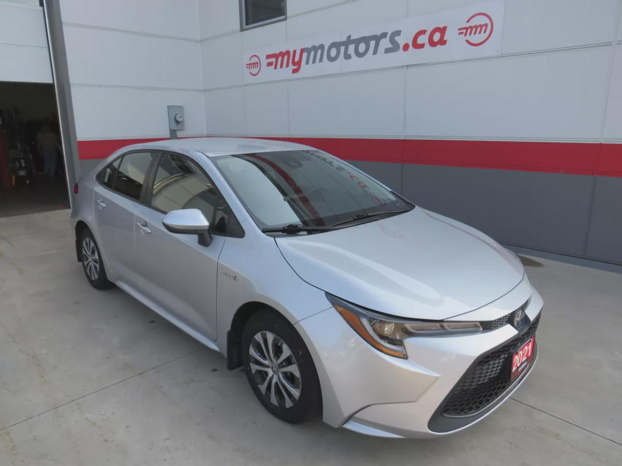 Used 2021 Toyota Corolla Hybrid (**VERY LOW KM!!**CLEAN TITLE/NO ACCIDENTS!!**SAFETY/CERTIFIED!!**HYBRID!!**LEATHER**WIRELESS PHONE CHARGING**PUSH BUTTON START**POWER SEATS**REVERSE CAMERA**DIGITAL TOUCHSCREEN**DRIVE MODES**HEATED SEATS**DIGITAL CLIMATE CONTROL**HEATED STEERING W for sale in Tillsonburg, ON