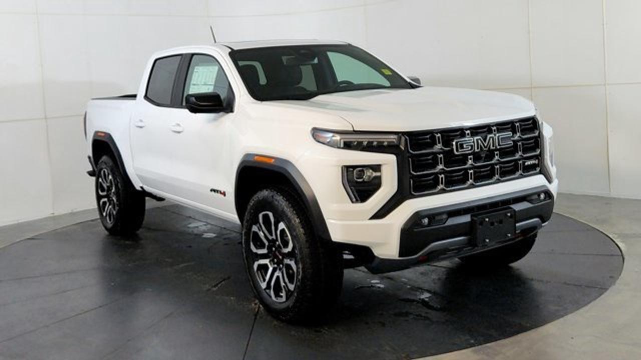 The 2026 GMC Canyon AT4 is an off-road--focused midsize pickup that comes standard with a 2-inch factory lift, an ultra-wide track, and 4WD equipped with a two-speed AutoTrac transfer case, automatic locking rear differential, and advanced Hill Descent Control. This unit rolls on 20 AT blackwalls overtop a black aluminum wheel. Under the hood, its powered by the potent TurboMax 2.7 L turbocharged inline-4 engine delivering 310 hp and 430 lb-ft of torque, with a max towing capacity of up to 7,700 lbs. Inside, the AT4 features a modern 11.3-inch center infotainment touchscreen, an 11-inch digital driver information display, leather heated and ventilated front seats, wireless charging, a sunroof and adaptive cruise control.