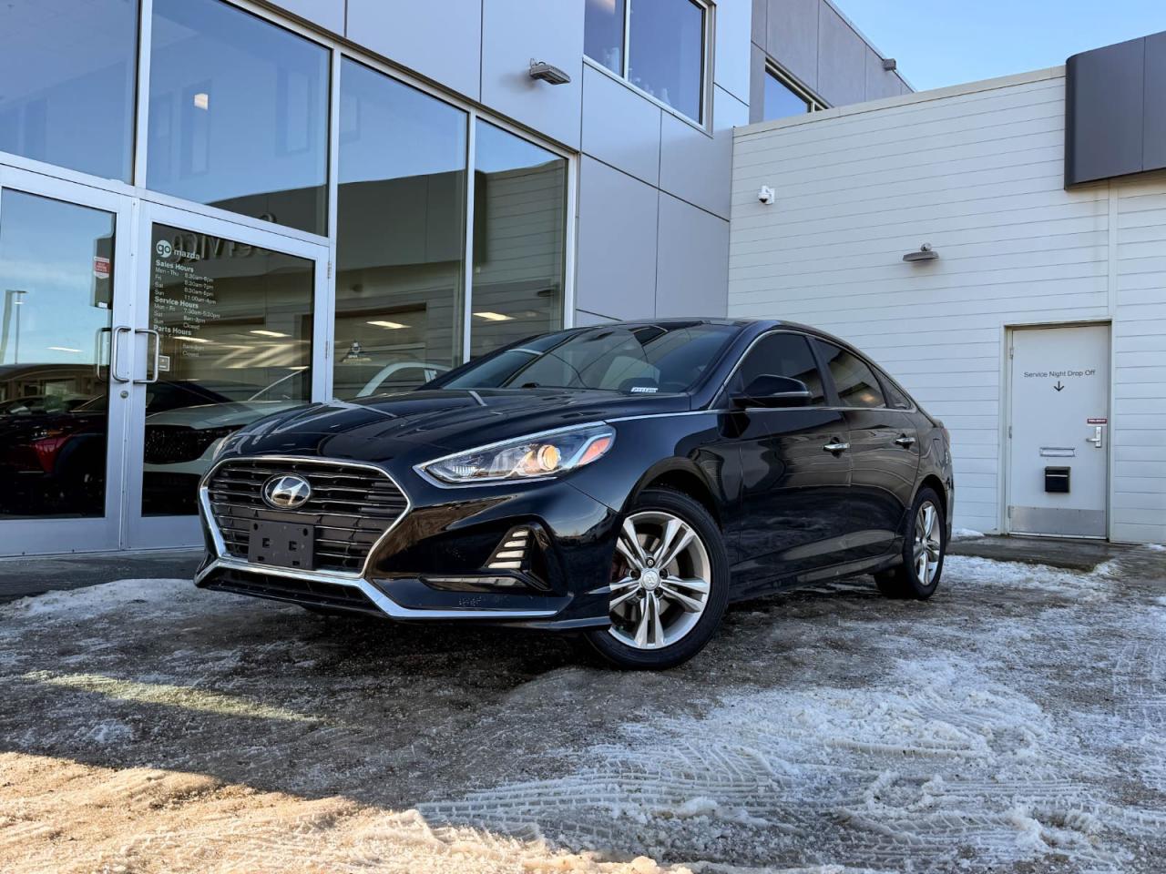 Discover exceptional value and style with this pre-owned 2019 Hyundai Sonata Preferred in sleek Black on Black. Powered by a reliable 2.4L I4 GDI engine paired with a smooth 6-speed automatic transmission featuring SHIFTRONIC, this sedan delivers 185HP of confident performance and fuel efficiency.Enjoy luxurious comfort with heated leather front bucket seats, dual-zone automatic climate control, and a spacious interior loaded with premium materials like leatherette door trims and piano black accents. The advanced infotainment system includes a 7-inch touchscreen, AM/FM/XM/MP3 audio, Bluetooth wireless streaming, and steering wheel-mounted voice and audio controls for seamless connectivity on the go.Drive with confidence thanks to key safety features such as blind spot warning, rear collision warning, multiple airbags, electronic stability control, and all-speed ABS with traction control. Additional conveniences include power windows and locks, smart key with push-button start, and a rearview camera.Stylish 17-inch aluminum alloy wheels, projector beam headlights with LED daytime running lights, heated power side mirrors, and a sunroof add to the Sonatas refined appeal. Whether commuting or cruising, this well-equipped Sonata Preferred combines comfort, technology, and safety in one sleek package.Schedule your test drive today and experience the perfect balance of value and sophistication!Go Mazda is an AMVIC licensed business.Please note: this vehicle has been registered in the province of British Columbia and is showing a CarFax incident in the amount of $2,630.61