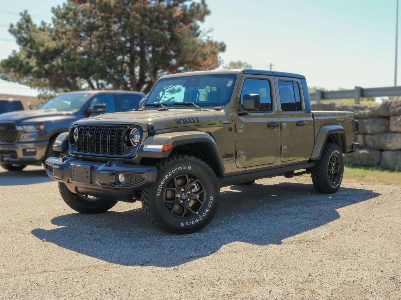 Our New 2026 Jeep Gladiator Willys 4X4 offers a thrilling combination of style and capability in 41 (Green)! Powered by a 3.6 Litre Pentastar V6 supplying 285hp to an 8 Speed Automatic transmission for muscular performance. A limited-slip rear differential, Dana axles, and an off-road suspension combine for trail-ready handling in this Four Wheel Drive truck, which scores approximately 10.7L/100km on the highway with a genuine Jeep exterior. Get a good look at our Gladiators LED lighting, exclusive Willys decals, black alloy wheels, padded sportbar, cab rock rails, 3-piece black Freedom hard top, and a Class II bumper hitch so youre ready to tow and go.  Supportive cloth seats are at your service for rewarding comfort in our Willys cabin. They complement a premium wrapped steering wheel, automatic climate control, keyless entry, pushbutton ignition, and modern technology for making the most of each trip. Highlights include a 12.3-inch touchscreen, a 7-inch driver display, an eight-speaker sound system, voice control, and smart connectivity with Apple CarPlay&reg;, Android Auto&reg;, Bluetooth&reg;, and WiFi/Alexa compatibility.  Remain safe as you roam free, enjoying peace of mind from a rearview camera with trailer-hitch zoom, automatic braking, forward collision warning, hill start assistance, trailer sway control, tire pressure monitoring, and more. A truck only Jeep could build, our Gladiator Willys needs a driver like you! Save this Page and Call for Availability. We Know You Will Enjoy Your Test Drive Towards Ownership!