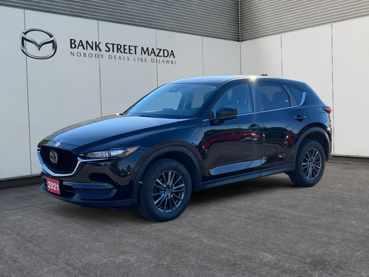 Experience the powerful performance and unmatched style of the 2021 Mazda CX-5 GS AWD. Cloaked in a sophisticated black exterior, this automatic AWD SUV promises a seamless and responsive driving experience, perfect for handling both city streets and rugged landscapes. The 2021 CX-5 boasts a striking exterior design enhanced by sleek alloy wheels that complement its dynamic presence. Step inside to find an interior that offers comfort and sophistication, filled with features like heated seats and power-adjustable options to enhance your drive. The elegant cabin also offers practical touches like power windows, keyless entry, and smart device integration for ultimate convenience. Equipped with innovative technology, this Mazda SUV includes a user-friendly backup camera, seamless Bluetooth connectivity, and a well-integrated smart device system. Safety is a priority with features like brake assist and lane assist, providing peace of mind on every journey. The advanced cruise control ensures a relaxed drive, while air conditioning keeps the cabin comfortable even during the longest rides. Ideal for families and adventure seekers alike, the 2021 Mazda CX-5 GS AWD is ready to elevate your driving experience. Contact our dealership today to learn more and take this exceptional SUV for a test drive. Dont miss the opportunity to own a vehicle that perfectly blends performance, style, and modern amenities.