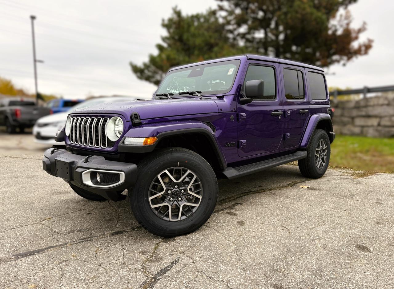 Our New 2026 Jeep Wrangler Sahara 4 Door 4X4 helps owners live the adventurous life in Reign (Purple)! Powered by a 3.6 Litre Pentastar V6 generating 285hp for an 8 Speed Automatic transmission thats eager for action. Dana axles and Command-Trac 4WD raise the bar for rugged performance, and this Four Wheel Drive SUV returns approximately 10.2L/100km on the highway with an iconic exterior design. Ready for open-air freedom with a removable body-color Freedom top and doors, our Wrangler boasts LED lighting, fog lamps, a body-color sport bar, alloy wheels, and robust skid plates for added off-road protection.  Upscale details, including heated leather front seats, a heated-wrapped steering wheel, automatic climate control, remote start, keyless access, pushbutton ignition, and 12V/115V power outlets, add extra comfort to our Sahara cabin. Our Wrangler also impresses in the infotainment department, thanks to a 12.3-inch touchscreen, a 7-inch driver display, WiFi compatibility, Apple CarPlay&reg;, Android Auto&reg;, Bluetooth&reg;, eight-speaker audio, and the trail-friendly tech benefits of Off-Road Info Pages. Its a comfortable cockpit for taking command!  Smart owners demand intelligent safety, and Jeep delivers with automatic braking, adaptive cruise control, forward collision warning, a rearview camera, hill start assist, trailer sway damping, and more. The world awaits, and our Wrangler Sahara is ready to go! Save this Page and Call for Availability. We Know You Will Enjoy Your Test Drive Towards Ownership!