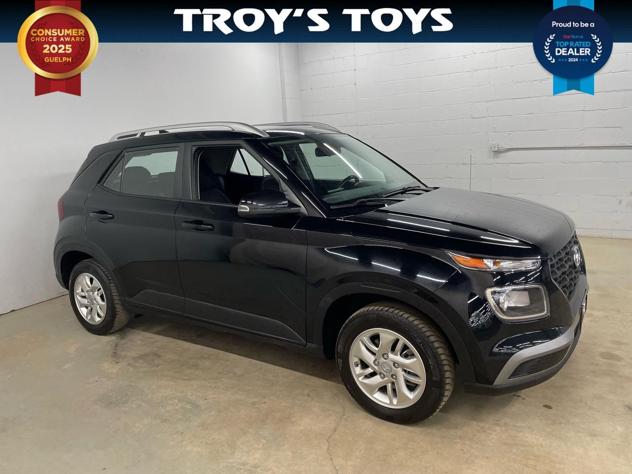 <p>Looking for a stylish and efficient ride thats perfect for navigating the city? Check out this sleek 2021 Hyundai Venue PREFERRED, now available at Troys Toys! This compact SUV boasts a striking black exterior thats sure to turn heads, complemented by a comfortable black interior. With its fuel-efficient gasoline engine and smooth Variable / CVT transmission, youll enjoy a responsive and economical driving experience, perfect for both daily commutes and weekend adventures. This Venue has been well-maintained and has 95,002km on the odometer. Its a fantastic choice for anyone seeking a reliable and modern vehicle.</p><p>The 2021 Hyundai Venue PREFERRED is designed to make every drive enjoyable. Its compact size makes parking a breeze, while still providing ample space for passengers and cargo. The front-wheel-drive configuration ensures confident handling in various weather conditions, and its four-door design offers easy access for everyone. This Venue is the perfect combination of practicality and style.</p><p>Here are a few of the features that make this 2021 Hyundai Venue PREFERRED really shine:</p><ul><li><strong>Fuel-Efficient Performance:</strong> Get ready to save at the pump with this economical engine!</li><li><strong>Sleek Black Exterior:</strong> Make a statement wherever you go with this head-turning colour.</li><li><strong>Comfortable Interior:</strong> Relax and enjoy the ride in this well-appointed cabin.</li><li><strong>User-Friendly Infotainment:</strong> Stay connected and entertained with the intuitive infotainment system.</li><li><strong>Compact and Agile:</strong> Easily navigate city streets and tight parking spots.</li></ul><p><strong><em>Powered by AutoIntelligence&trade;</em></strong> Vehicle information has been generated using artificial intelligence and is provided for informational purposes only. While efforts are made to ensure accuracy, please confirm all details directly with the dealer.</p>