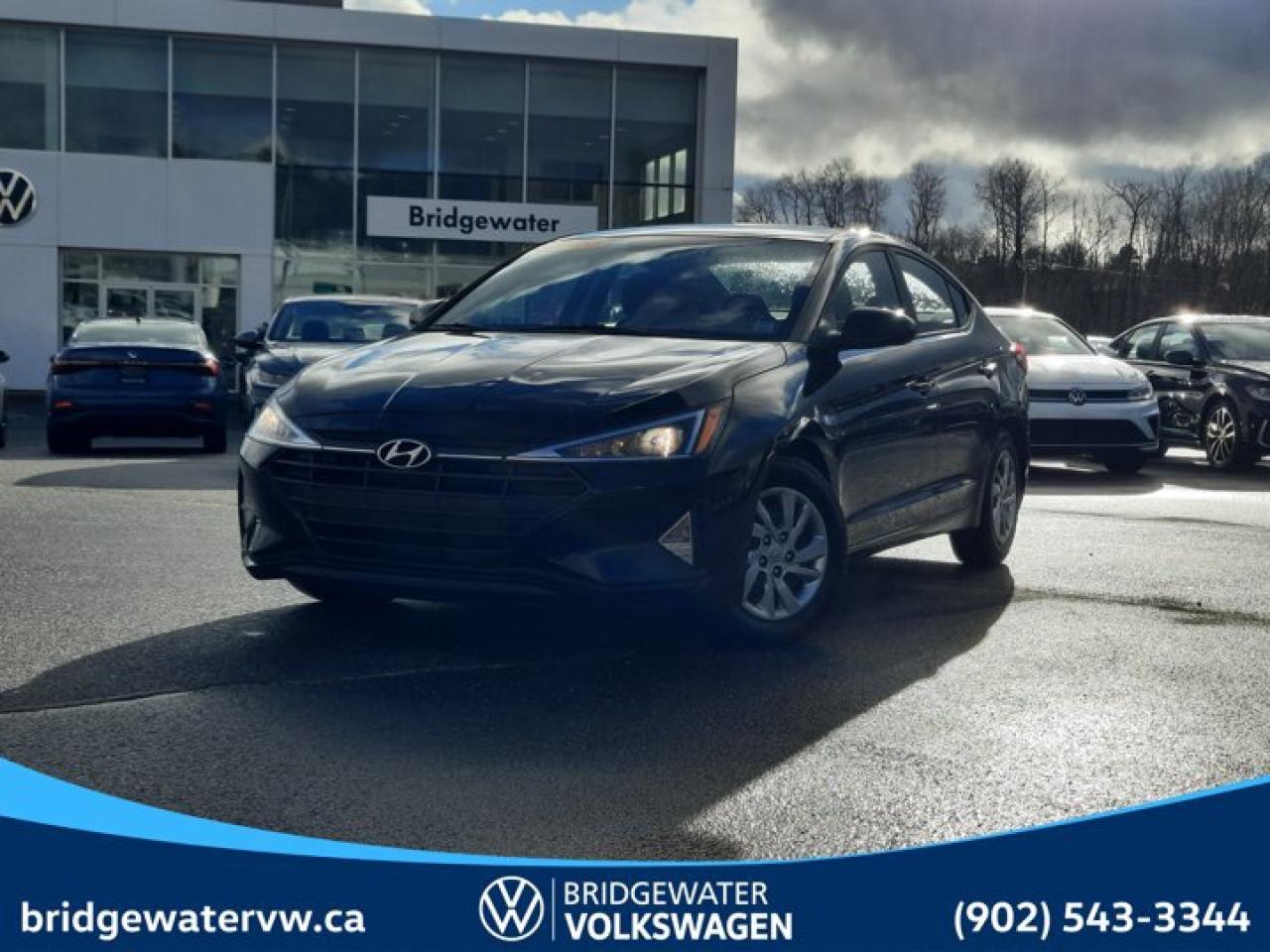 Black Pearl 2020 Hyundai Elantra Essential Apple CarPlay | Android Auto FWD CVT I4 Bridgewater Volkswagen, Located in Bridgewater Nova Scotia.6 Speakers, ABS brakes, Air Conditioning, AM/FM radio, Brake assist, Bumpers: body-colour, Delay-off headlights, Driver door bin, Driver vanity mirror, Dual front impact airbags, Dual front side impact airbags, Electronic Stability Control, Exterior Parking Camera Rear, Front anti-roll bar, Front Bucket Seats, Front reading lights, Front wheel independent suspension, Heated door mirrors, Heated Front Bucket Seats, Heated front seats, Illuminated entry, Knee airbag, Occupant sensing airbag, Outside temperature display, Overhead airbag, Overhead console, Panic alarm, Passenger door bin, Passenger vanity mirror, Power door mirrors, Power steering, Power windows, Premium Cloth Seating Surfaces, Radio: AM/FM/MP3 Audio System, Rear window defroster, Remote keyless entry, Security system, Speed-sensing steering, Split folding rear seat, Tachometer, Telescoping steering wheel, Tilt steering wheel, Traction control, Trip computer, Variably intermittent wipers, Wheels: 15 x 6.0J Silver Steel.Certification Program Details: 150 Points Inspection Fresh Oil Change Free Carfax Full Detail 2 years MVI Full Tank of Gas The 150+ point inspection includes: Engine Instrumentation Interior components Pre-test drive inspections The test drive Service bay inspection Appearance Final inspectionReviews:* Owners report a comfortable and durable driving feel, solid ride quality on even rougher roads, good feature content for the dollar, and an upscale look and feel to the interior and driving environment. The touchscreen infotainment system is highly rated for effectiveness and ease of use. Source: autoTRADER.ca