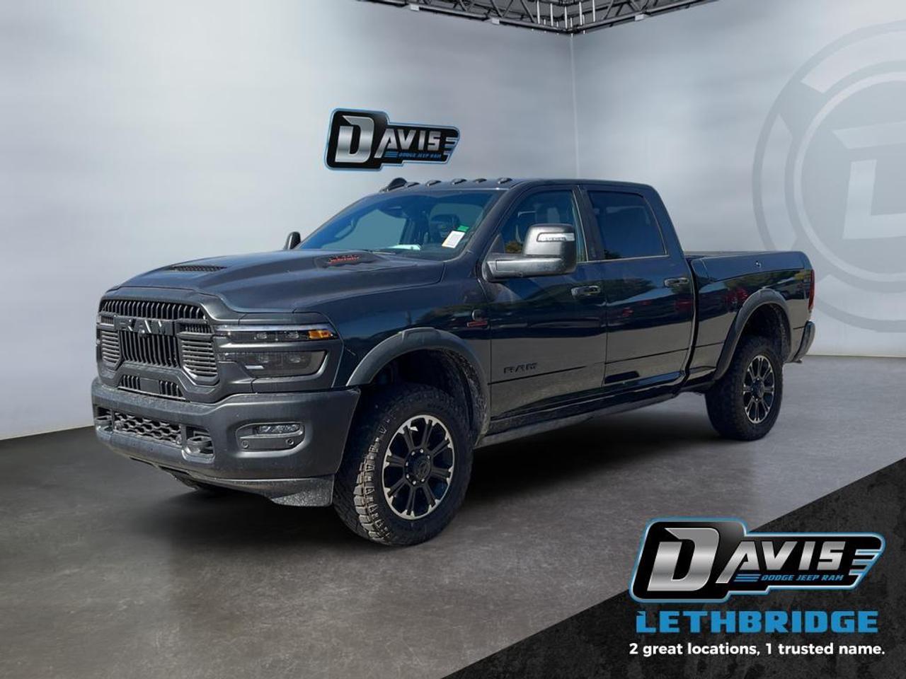 <b>Adaptive Cruise, Navigation, Heated Seats, Blind Spot Detection, Remote Start, Heated Steering Wheel!<br /> <br /></b><br /> <br /> <br />Conquer any terrain with the 2026 Ram 2500 Rebel Crew Cab in Forged Blue Metallic with Lower Two-Tone Paint. Powered by the 6.7L Cummins Turbo Diesel I6 engine paired with an 8-speed TorqueFlite HD automatic transmission and 4x4 Rebel Performance Suspension, this heavy-duty truck delivers rugged capability with trailering, off-road, and work-ready performance.<br /><br />The exterior impresses with 20 Black Diamond-Cut aluminum wheels, LT285/60R20 all-terrain tires, powder-coated bumpers, LED lighting, black wheel flares, and deployable running boards. Inside, enjoy leather-trimmed heated and ventilated bucket seats, dual-zone climate control, folding 60/40 rear seat, Uconnect 5 NAV with 14.4 touchscreen, Apple CarPlay, Android Auto, Alexa built-in, 17-speaker Harman Kardon audio, and dual wireless charging.<br /><br />Safety and convenience are enhanced with adaptive cruise control with stop, ParkView rear camera, ParkSense front/rear park assist, blind-spot monitoring with cross-path detection, Class V receiver hitch, trailer sway damping, tow hooks, and tip start. The 2026 Ram 2500 Rebel is the ultimate combination of power, luxury, and technology for work and adventure.<br /> <br />To apply right now for financing use this link: <a href=https://lethbridge.davisdodge.ca/free-credit-check/ target=_blank rel=nofollow noopener noreferrer>https://lethbridge.davisdodge.ca/free-credit-check/</a><br /><br /> <br /><br />As a premier Chrysler, Dodge, Jeep and RAM dealership, Davis Dodge proudly offers an extensive selection of new and used vehicles to meet every drivers needs. Customers across Lethbridge, Fort Macleod, Taber, Claresholm, Coaldale, and beyond trust us for daily vehicle specials, certified service and parts, and a seamless online inventory experience. <br /><br /> With competitive financing options and expert support, we make car buying easy and enjoyable. <br /><br /> Ready to hit the road? Schedule your test drive today at Davis Dodge, your trusted Chrysler, Dodge, Jeep and RAM dealer in Lethbridge, Alberta.<br /><br /> Vehicle pricing offer shown expires 2026-04-30. <br /> Come by and check out our fleet of 70+ used cars and trucks and 110+ new cars and trucks for sale in Lethbridge. o~o