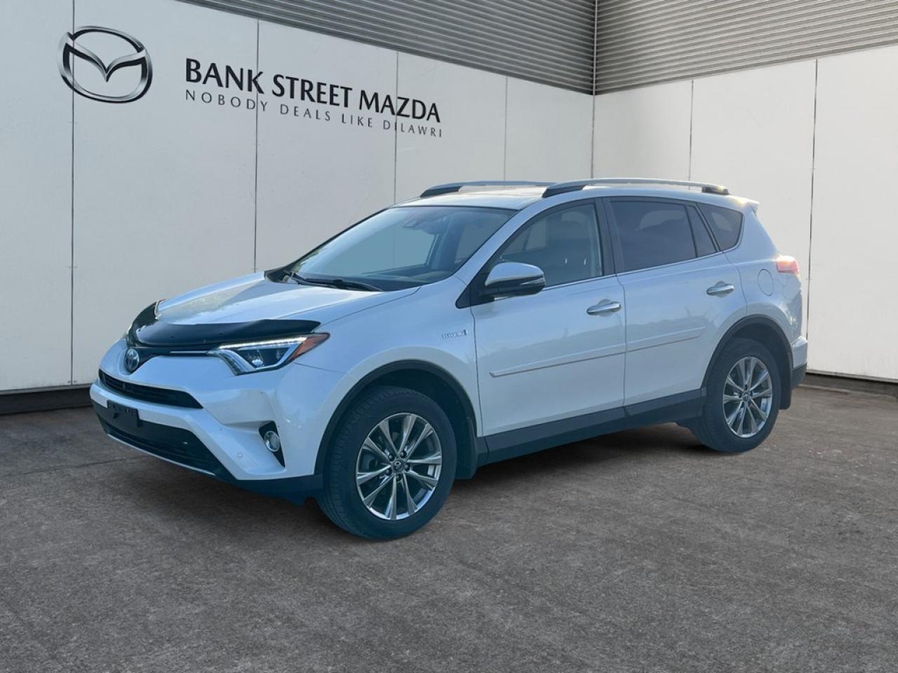 Introducing the elegant 2018 Toyota RAV4 Hybrid Limited in pristine white! This AWD SUV offers confidence in all driving conditions, thanks to its responsive handling and the efficient 2.5L 4-cylinder engine. Paired with an automatic transmission, this RAV4 does not compromise on performance or fuel economy. The exterior boasts sleek lines, complemented by striking alloy wheels and a convenient sunroof/moonroof that invites the sunshine in. Inside, the cabin is crafted for comfort and style with features like heated front seats and a plush leather steering wheel. Youll find modern conveniences such as keyless entry, power seats, and power windows, ensuring ease at every touch. Stay connected and entertained with smart device integration, a comprehensive navigation system, and satellite radio all at your fingertips. Safety takes top priority with advanced features like a backup camera, lane assist, adaptive cruise control, and parking sensors, designed to keep you and your passengers secure on every journey. This RAV4 Hybrid Limited is perfect for families who crave adventure without sacrificing efficiency or style. Ready to elevate your driving experience? Contact our dealership today for further details or to schedule a test drive!