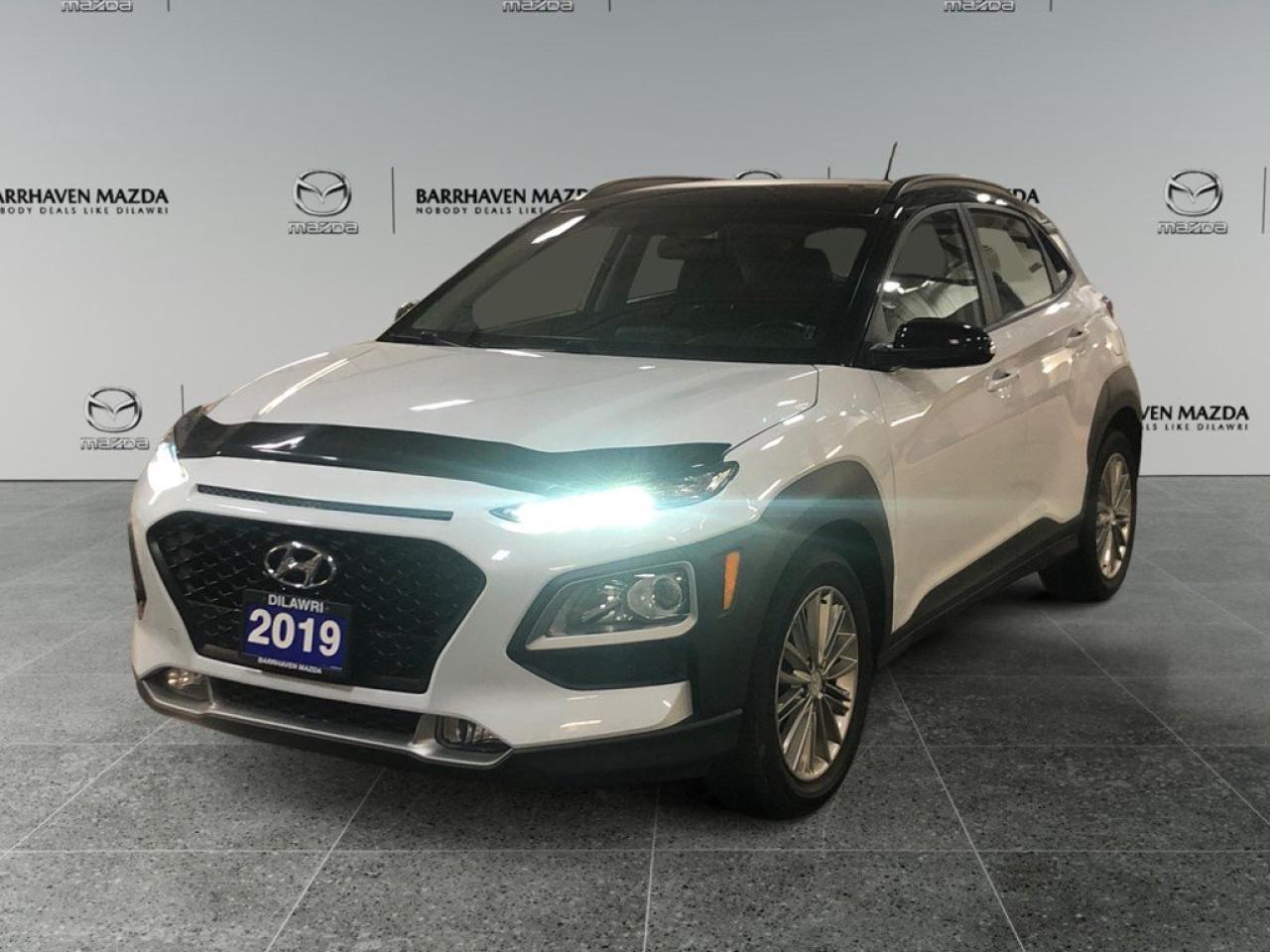 The 2019 Hyundai Kona 2.0L Preferred FWD with Two-Tone Roof is a captivating blend of form and function. Gliding effortlessly with its Front-Wheel Drive, this white SUV is designed to make every drive a pleasure, handling city streets and highways with confidence. The exterior of the Kona shows off a modern and durable look, enhanced with alloy wheels and a unique two-tone roof that sets it apart from the crowd. Its well-appointed interior boasts heated front seats, a leather-wrapped steering wheel, and premium leather/metal-look gear shifter material, ensuring comfort and style with every journey. On the technology front, stay connected and secure with a host of features including Bluetooth connection, smart device integration, and a user-friendly infotainment system. Advanced safety features such as lane assist, parking sensors, and a backup camera provide peace of mind, making each drive as secure as it is enjoyable. Ideal for those seeking a reliable and stylish vehicle without compromising on modern conveniences. If youre in the market for an SUV that offers a perfect balance of performance, safety, and sophistication, contact our dealership today to learn more about the 2019 Hyundai Kona Preferred. Its time to take your driving experience to the next level.