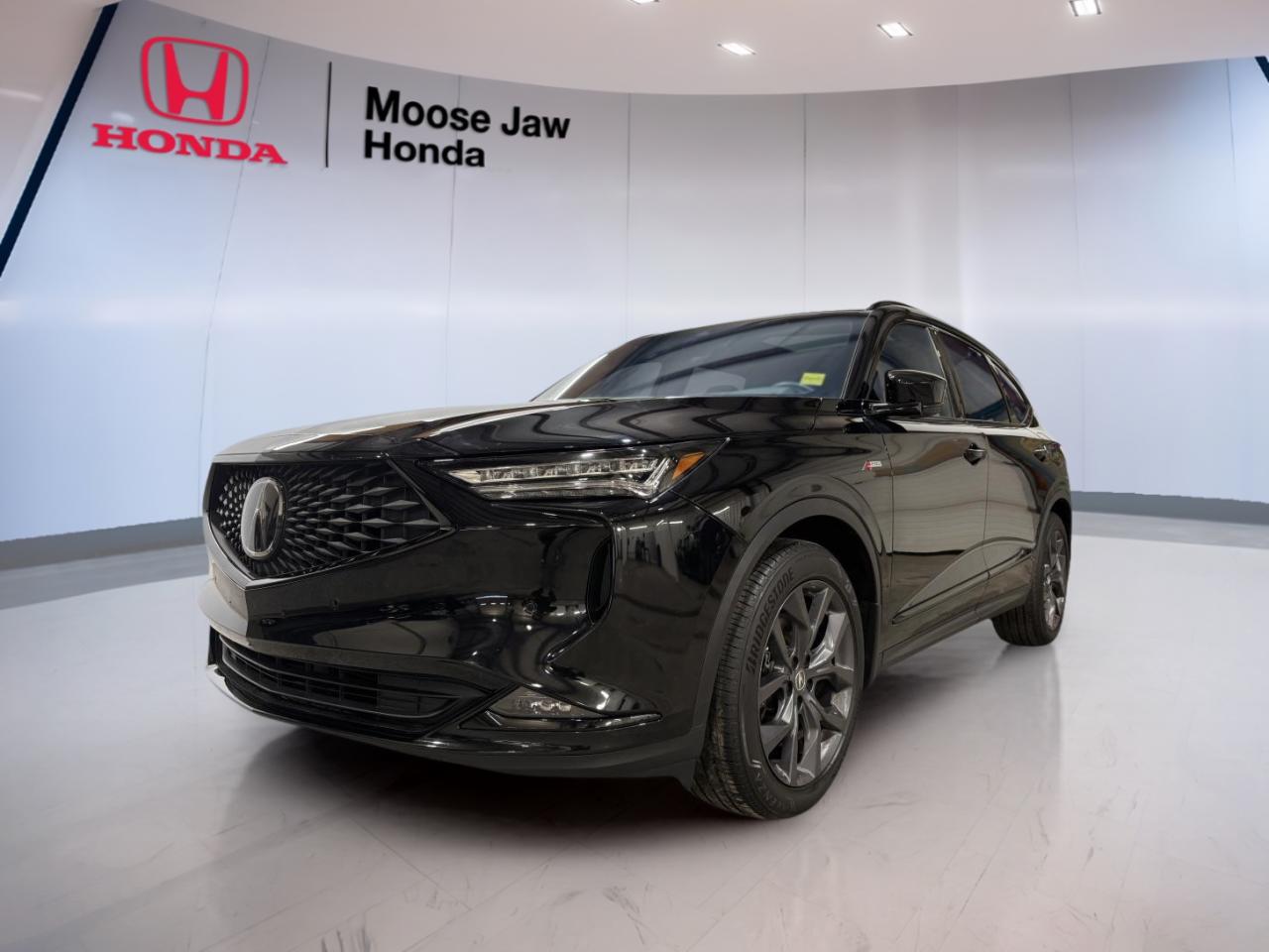 Experience dynamic luxury and striking performance with the 2022 Acura MDX A-Spec, now available at Moose Jaw Honda. This used SUV stands out with a bold black exterior and a sophisticated design, making it a perfect fit for families and drivers seeking versatility and style. With only 60,384 km on the odometer, this MDX A-Spec blends reliability with advanced features for a confident drive in Moose Jaw and beyond.

FEATURES OF THE MDX A-Spec  
»» Exclusive A-Spec styling elements and accents  
»» Sport-inspired, flat-bottom steering wheel  
»» 20-inch Shark Grey alloy wheels  
»» LED fog lights for enhanced visibility  

ADVANCED SAFETY FEATURES  
»» Blind spot information system for safer lane changes  
»» Rear cross traffic monitor for reversing confidence  
»» Forward collision warning with automatic emergency braking  
»» Lane keeping assist system for added security  

PERFORMANCE AND EFFICIENCY  
»» 3.5L SOHC i-VTEC V6 engine with direct injection  
»» 10-speed automatic transmission with paddle shifters  
»» All-wheel drive for enhanced traction and control  
»» Responsive acceleration for confident highway merging  

COMFORT AND CONVENIENCE  
»» Spacious seating for up to seven passengers  
»» Tri-zone automatic climate control for personalized comfort  
»» Power-adjustable front seats for easy customization  
»» Ample legroom in all three rows  

TECHNOLOGY AND CONNECTIVITY  
»» Integrated navigation system for easy route planning  
»» Premium audio system for immersive sound  
»» Apple CarPlay and Android Auto compatibility  
»» Wireless charging pad for device convenience  

CARGO SPACE  
»» Generous cargo area behind third row  
»» Split-folding rear seats for flexible storage  
»» Underfloor storage compartment for valuables  
»» Easy-access power tailgate for loading ease  

WHAT OTHER OWNERS LIKE  
»» Smooth and powerful V6 engine performance  
»» Comfortable ride with advanced suspension  
»» High-quality, user-friendly infotainment system  
»» Stylish and sporty exterior design  

This 2022 Acura MDX A-Specs VIN is: 5J8YE1H05NL804235.