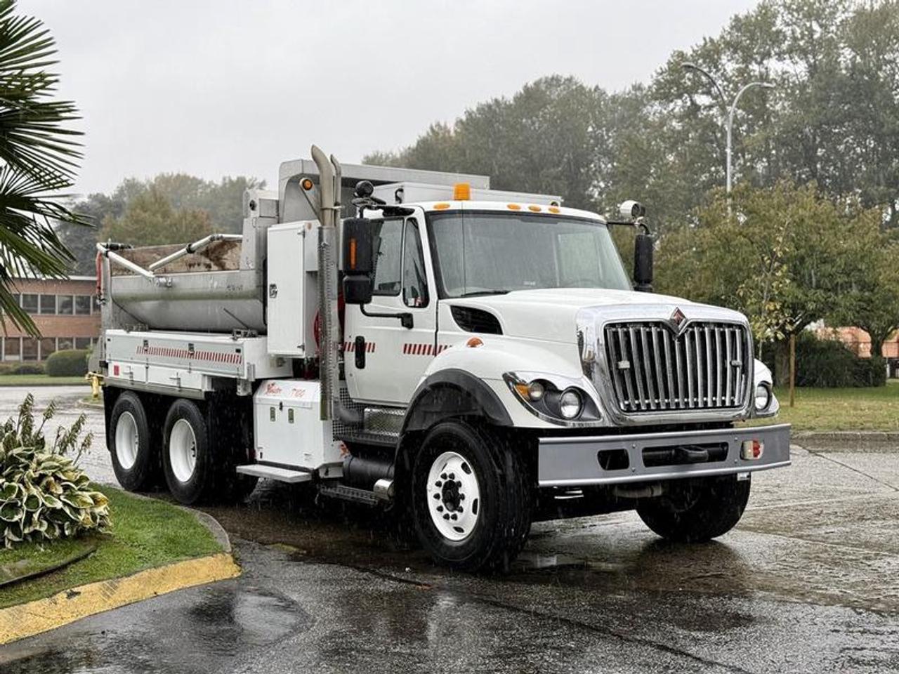2011 International 7500 tandem axle dump truck with Twister T100 sander, powered by a 9.3L diesel engine and equipped with an automatic Allison transmission. Features PTO, differential lock, trailer air supply, air suspension dump, tarp control, and multiple lighting switches including strobe, light bar, step, and rear arrow signal lights. Includes foldable side ladder for dump access, tool box compartments (1000 lb max load), interior Espar heating valves, and air brakes. The 12-foot dump box measures 78 wide and 4 high. White exterior over grey cloth interior with cruise control, AM/FM radio, power windows, locks, and mirrors. GVWR 54,000 lbs. Suitable for winter or year-round municipal service.  $65,820.00 plus $375 processing fee, $66,195.00 total payment obligation before taxes.   Listing report, warranty, contract commitment cancellation fee, financing available on approved credit (some limitations and exceptions may apply). All above specifications and information is considered to be accurate but is not guaranteed and no opinion or advice is given as to whether this item should be purchased. We do not allow test drives due to theft, fraud, acts of vandalism and undetectable impaired driving. Instead we provide the following benefits: Complimentary Warranty (with options to extend), Limited Money Back Satisfaction Guarantee on Fully Completed Contracts, Contract Commitment Cancellation, and an Open-Ended Sell-Back Option. Ask seller for details or call 604-522-REPO(7376) to confirm listing availability.