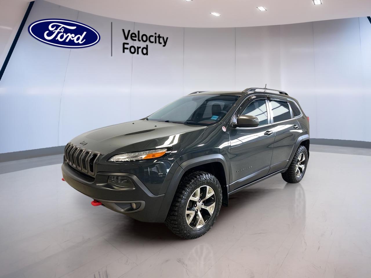 Discover the rugged capability and bold style of the 2016 Jeep Cherokee Trailhawk, now available at Velocity Ford in Moose Jaw. With a striking black exterior and 205,147 km on the odometer, this used SUV is engineered for adventure. Its 3.2L Pentastar VVT V6 engine with Engine Stop-Start technology and 9-speed automatic transmission delivers a dynamic driving experience. Four-wheel drive ensures youre ready for any terrain, making this Cherokee Trailhawk the perfect companion for Canadian roads and trails.

FEATURES OF THE Cherokee Trailhawk  
»» 3.2L Pentastar VVT V6 with ESS  
»» 9-speed automatic transmission with Active Drive  
»» Trail Rated four-wheel drive capability  
»» Distinctive black exterior for a bold presence  

ADVANCED SAFETY FEATURES  
»» Comprehensive airbag system for all-around protection  
»» Electronic Stability Control for enhanced handling  
»» Four-wheel anti-lock disc brakes for secure stops  
»» Hill Start Assist to prevent rollback  

PERFORMANCE AND EFFICIENCY  
»» 3.2L Pentastar V6 delivers robust power  
»» Engine Stop-Start system improves fuel efficiency  
»» 9-speed automatic transmission for smooth shifting  
»» 4-wheel drive for reliable off-road traction  

COMFORT AND CONVENIENCE  
»» Spacious cabin with flexible seating  
»» Dual-zone climate control for personalized comfort  
»» Power windows and door locks for ease  
»» Ample legroom for driver and passengers  

TECHNOLOGY AND CONNECTIVITY  
»» Touchscreen infotainment system for easy access  
»» Bluetooth connectivity for hands-free calls  
»» USB ports for device charging and music  
»» Integrated voice command for safer operation  

CARGO SPACE  
»» Split-folding rear seats for versatile storage  
»» Generous cargo area for gear and groceries  
»» Rear cargo tie-downs to secure items  
»» Easy-access liftgate for loading convenience  

WHAT OTHER OWNERS LIKE  
»» Confident off-road performance in all conditions  
»» Comfortable ride quality on long journeys  
»» User-friendly infotainment and connectivity features  
»» Distinctive Trailhawk styling and presence  

This 2016 Jeep Cherokee Trailhawks VIN is: 1C4PJMBS4GW199997.