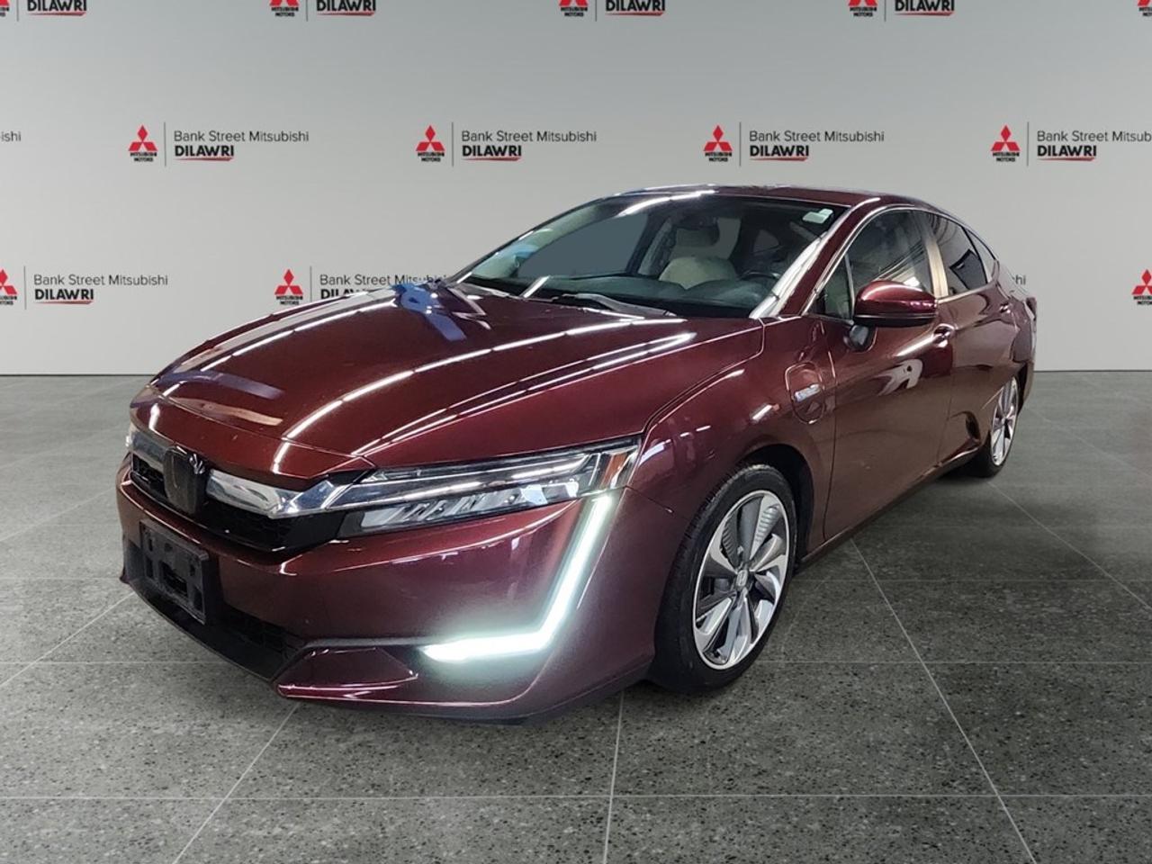 Balance of 5 year/100,000kms BASIC warranty and 10 year/160,000kms Factory Powertrain Warranty on ALL MITSUBISHI products! Best in the industry!!!! Step into pure sophistication with the 2019 Honda Clarity Plug-In Hybrid Touring Sedan in dazzling white, featuring a front-wheel-drive system renowned for its exceptional handling. This vehicle offers an excellent blend of efficiency and comfort, powered by a robust 1.5L 4-cylinder engine, developing 212 HP at 5500 RPM, capable of providing an exhilarating drive while maintaining remarkable fuel economy. The sleek exterior is accentuated by stylish alloy wheels and distinctive lines that make a statement on any road. Inside, the cabin is meticulously designed with high-grade materials, featuring luxurious leather seats and a refined leather-trimmed steering wheel. Comfort and convenience are amplified with heated front seats, a climate control system, and smart keyless entry. Tech enthusiasts and safety-conscious drivers will be impressed by the extensive technology suite. The advanced navigation system, seamless Bluetooth connection, and satellite radio ensure you stay connected no matter where you are. The vehicle is equipped with state-of-the-art safety features such as lane assist, brake assist, and a backup camera, complemented by adaptive cruise control for a stress-free driving experience. Whether youre a commuter seeking fuel efficiency or a tech-savvy individual interested in the latest driver-assist technologies, the Honda Clarity Plug-In Hybrid Touring Sedan is designed with you in mind. Contact our dealership today for more information or to schedule a test drive!