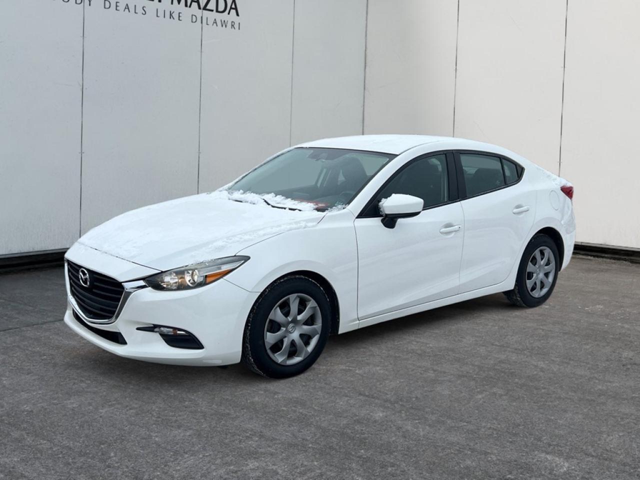 Introducing the 2017 Mazda Mazda3 GX, a sophisticated white FWD sedan known for its agile handling and responsive drive. Experience the smooth performance of a 2.0L 4-cylinder engine paired with a hassle-free automatic transmission, making your everyday journeys both enjoyable and efficient. The Mazda3 GXs exterior is both stylish and practical, offering a streamlined silhouette that ensures a pleasing aesthetic whether youre commuting through city streets or cruising on the highway. Inside, youll find a well-appointed cabin emphasizing comfort and simplicity, equipped with power windows and convenient keyless entry to enhance your driving experience. This sedan is packed with the latest technology and safety features, such as brake assist, ensuring peace of mind with every trip. The intuitive design of the controls and driver assistance features assures a safe journey for you and your passengers. If youre a city commuter or a new driver looking for a reliable and contemporary car, the 2017 Mazda3 GX is worth considering. We invite you to contact us at the dealership for more information and to see how this vehicle can fit seamlessly into your life.
