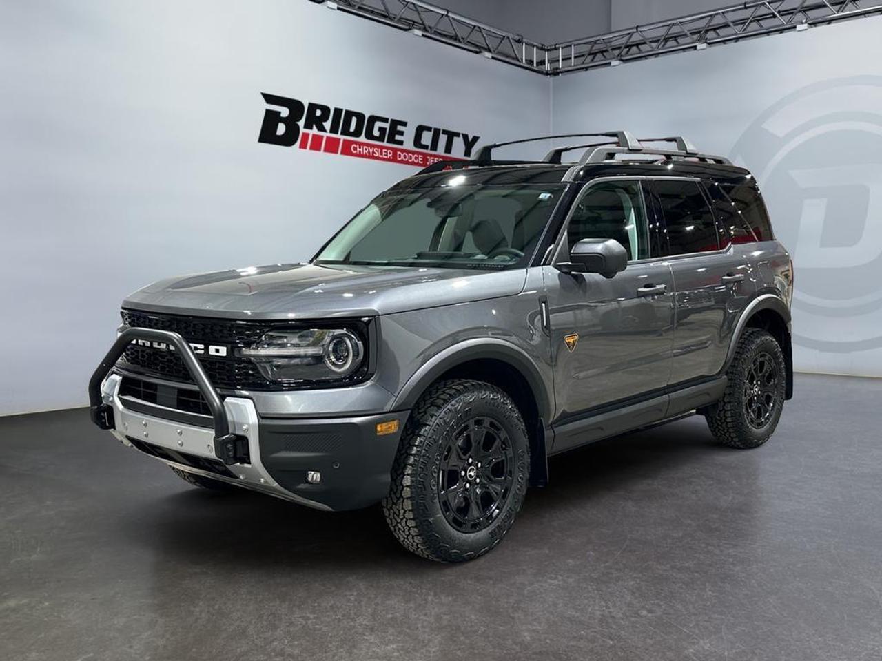 <b>4WD - Sunroof - Sasquatch Badlands Pkg - Technology Pkg - Leather - A/T Wheels - Low Km's - Local Trade In! <br /> <br /></b><br /> This 2025 Ford Bronco Sport is no rip-off of its bigger brother; it's an off road-capable and versatile compact SUV. This 2025 Ford Bronco Sport is for sale today in Lethbridge. <br /> <br />A compact footprint, an iconic name, and modern luxury come together to make this Bronco Sport an instant classic. Whether your next adventure takes you deep into the rugged wilds, or into the rough and rumble city, this Bronco Sport is exactly what you need. With enough cargo space for all of your gear, the capability to get you anywhere, and a manageable footprint, there's nothing quite like this Ford Bronco Sport.This low mileage SUV has just 8,690 kms. Stock number 40758 is nice in colour . It has an automatic transmission and is powered by a 250HP 2.0L 4 Cylinder Engine. <br /> <br /> Our Bronco Sport's trim level is Badlands. Rugged and capable, this Bronco Sport Badlands is ready for your next off-road adventure, with beefy off-road suspension, a reinforced undercarriage with 4 skid plates, off-road wheels, and front tow hooks. Also standard include heated seats with SiriusXM streaming radio and exclusive aluminum wheels. This SUV also features a slew of standard infotainment and convenience features, including voice-activated automatic air conditioning, a 12-inch SYNC 4 powered infotainment screen with Apple CarPlay and Android Auto, smart charging USB type-A and type-C ports, 4G LTE mobile hotspot internet access, proximity keyless entry with remote start, and a robust terrain management system that features the trademark Go Over All Terrain (G.O.A.T.) driving modes. Additional features include blind spot detection, rear cross traffic alert and pre-collision assist with automatic emergency braking, lane keeping assist, lane departure warning, forward collision alert, driver monitoring alert, a rear-view camera, 3 12-volt DC and 120-volt AC power outlets, and so much more. This vehicle has been upgraded with the following features: Off-road Package, Heated Seats, Siriusxm, Apple Carplay, Android Auto, Remote Start, Blind Spot Detection. <br /> <br />To apply right now for financing use this link : <a href=https://www.bridgecitychrysler.com/pre-approval/ target=_blank rel=nofollow noopener noreferrer>https://www.bridgecitychrysler.com/pre-approval/</a><br /><br /> <br /><br />Locally Owned & Trusted for Over 35 Years  Bridge City Chrysler in Lethbridge, AB <br /><br /> At Bridge City Chrysler, weve proudly served the Lethbridge community for more than 35 years, offering an unparalleled car buying experience. Dont just take our word for itour Google reviews speak volumes about our commitment to exceptional service. <br /><br /> Delivery & At-Home Test Drives: Convenient options to suit your lifestyle. <br /><br /> Flexible Financing for Everyone: Get the vehicle you need with financing solutions tailored to your situation. <br /><br /> Full Mechanical Inspections & Professional Cleaning: Every vehicle is thoroughly inspected and cleaned before it hits our lot.<br /><br /> We take all makes and models on trade and offer competitive pricing with inventory that changes daily. Whether you're shopping for a Chrysler, Dodge, Jeep, RAM, or FIAT, our AMVIC Licensed dealership makes it easy to browse, buy, and drive away.<br /><br /> Located in Lethbridge, AB, we proudly serve customers in Fort Macleod, Taber, Claresholm, and Coaldale. Shop online or visit us today to experience the best in sales, service, and selection. Standard bank rates apply; taxes are additional.<br /><br /> Vehicle pricing offer shown expires 2025-12-31. <br /> Come by and check out our fleet of 100+ used cars and trucks and 140+ new cars and trucks for sale in Lethbridge. o~o