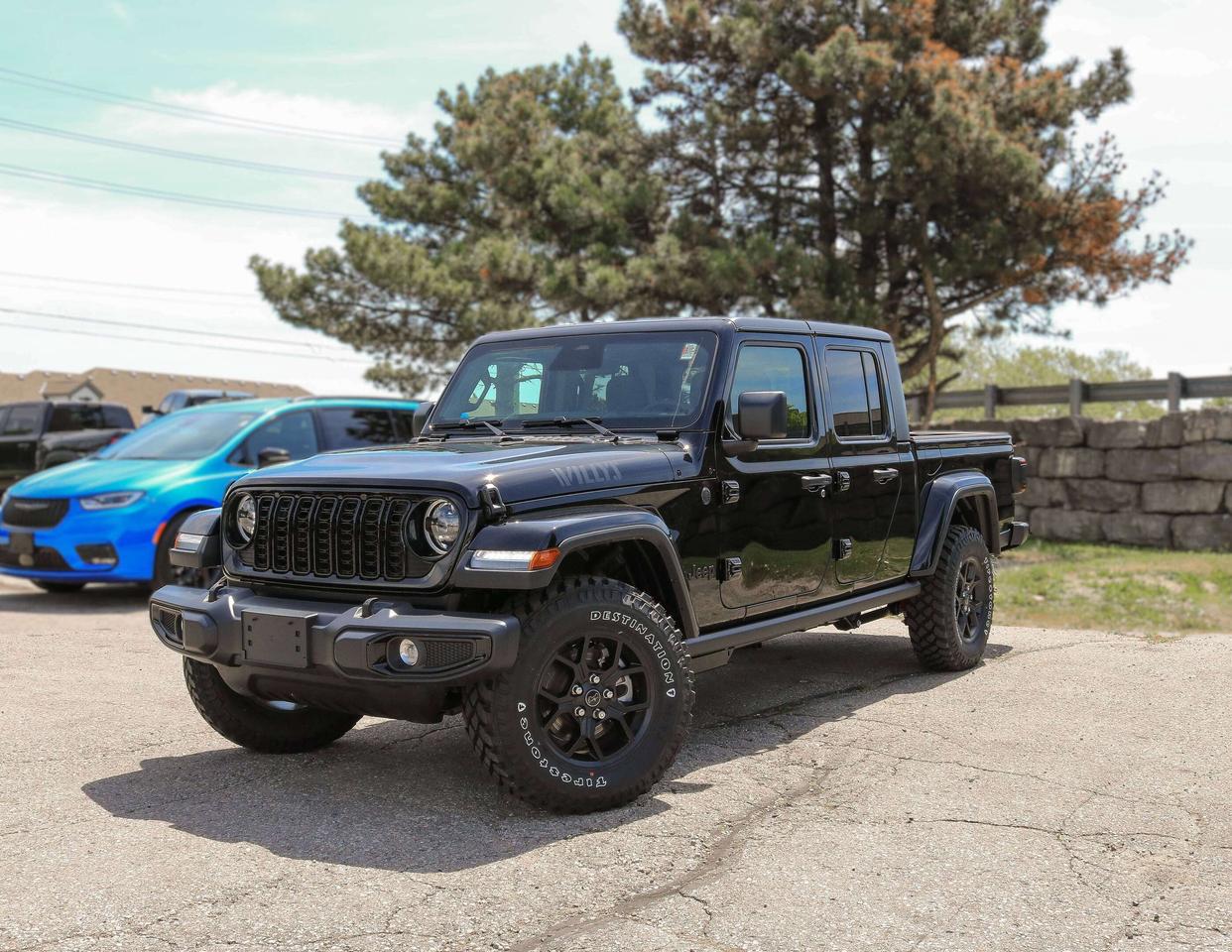 With its aggressive stance and off-road-focused features, our New 2026 Jeep Gladiator Willys 4X4 with the Convenience Pack stands out as a capable, confident choice for outdoor enthusiasts in Black! Powered by a 3.6 Litre Pentastar V6 supplying 285hp to an 8 Speed Automatic transmission for muscular performance. A limited-slip rear differential, Dana axles, and an off-road suspension combine for trail-ready handling in this Four Wheel Drive truck, which scores approximately 10.7L/100km on the highway with a genuine Jeep exterior. Get a good look at our Gladiators LED lighting, exclusive Willys decals, black alloy wheels, padded sportbar, cab rock rails, black Freedom top hardtop, Class II bumper hitch, and Convenience Pack upgrades like a Gorilla Glass windshield and body-color fender flares.  Inside the Willys cabin, our Convenience Packs heated cloth front seats, heated wrapped steering wheel, and remote-start system are at your service for rewarding comfort. They complement automatic climate control and modern technology for making the most of each trip. Highlights include a 12.3-inch touchscreen, a 7-inch driver display, an eight-speaker sound system, voice control, and smart connectivity with Apple CarPlay&reg;, Android Auto&reg;, Bluetooth&reg;, and WiFi/Alexa compatibility.  Remain safe as you roam free, enjoying peace of mind from a rearview camera with trailer-hitch zoom, automatic braking, forward collision warning, hill start assistance, trailer sway control, tire pressure monitoring, and more. A truck only Jeep could build, our Gladiator Willys needs a driver like you! Save this Page and Call for Availability. We Know You Will Enjoy Your Test Drive Towards Ownership!