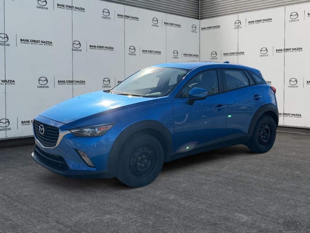 The 2016 Mazda CX-3 GS AWD is an enticing compact SUV, boasting a striking exterior in a charming hue tailored for the adventurous spirit. Equipped with an AWD drivetrain and smooth automatic transmission, it promises an assured drive, whether youre navigating city streets or taking on winding country roads. The exterior is adorned with stylish alloy wheels, while the versatile 4-door design enhances functionality. Step inside to experience a well-thought-out interior that features a leatherette instrument panel and a leather/metal-look gear shifter, adding an extra touch of refinement. Comfort is championed with heated front seats, heated mirrors, and seamless keyless entrya nod to luxury in everyday life. Beneath its contemporary facade, technology takes the front seat. Enjoy the convenience of a backup camera, Bluetooth connectivity, and cruise control, each feature enhancing your driving experience. Safety and assistance are pivotal, with brake assist ensuring added peace of mind on the road. This model appeals to those seeking a blend of style, functionality, and advanced features. Dont miss the opportunity to elevate your driving experience with this exceptional SUV. Contact our dealership today to find out more!